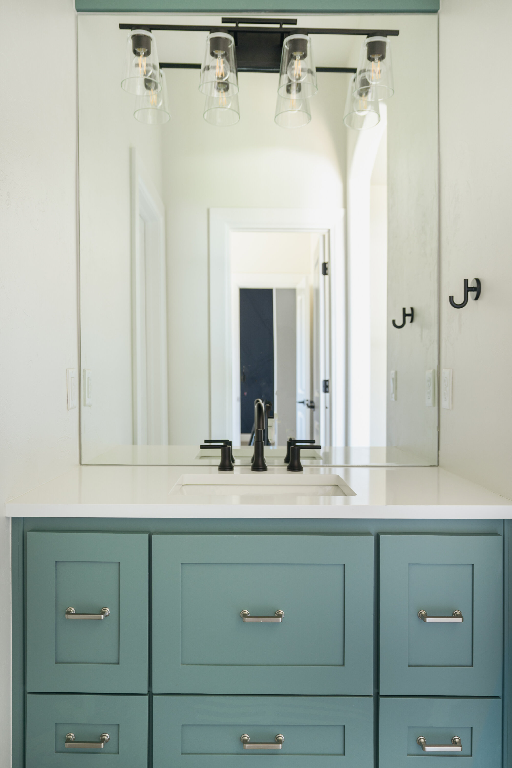 Green painted powder room cabinets 