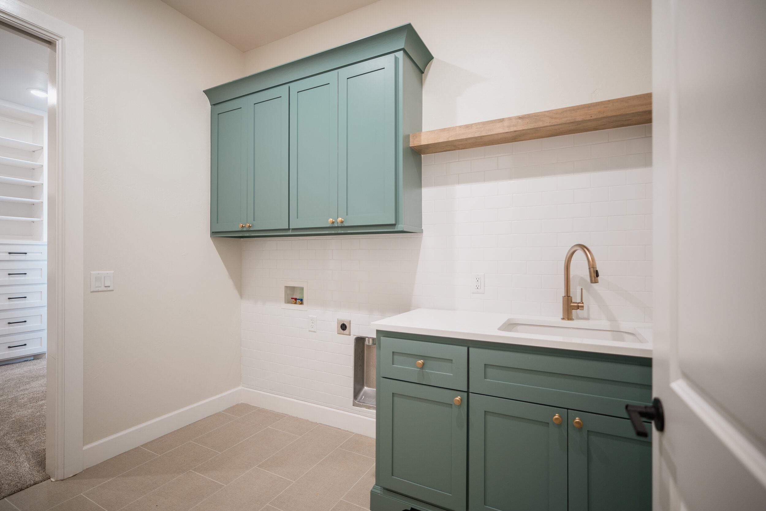 Painted green laundry room cabinets 