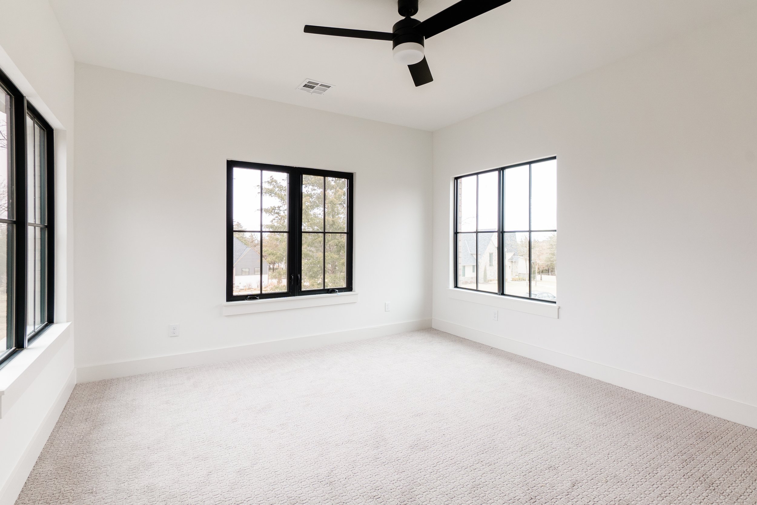 Open room with black ceiling fan