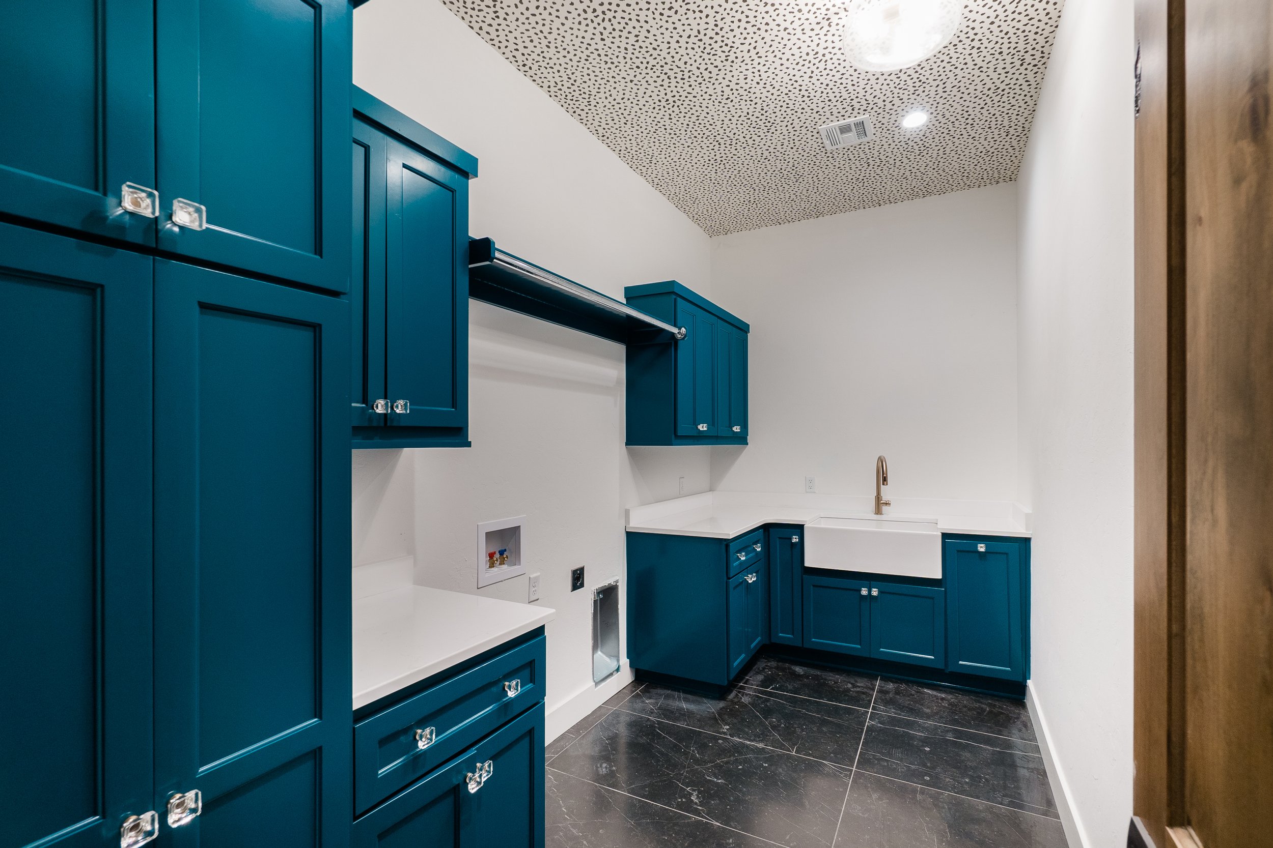 Blue painted laundry room cabinets 