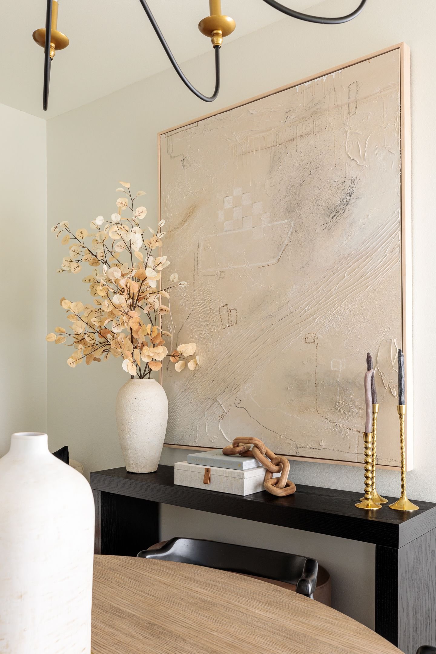 Neutral painting and black entry table  