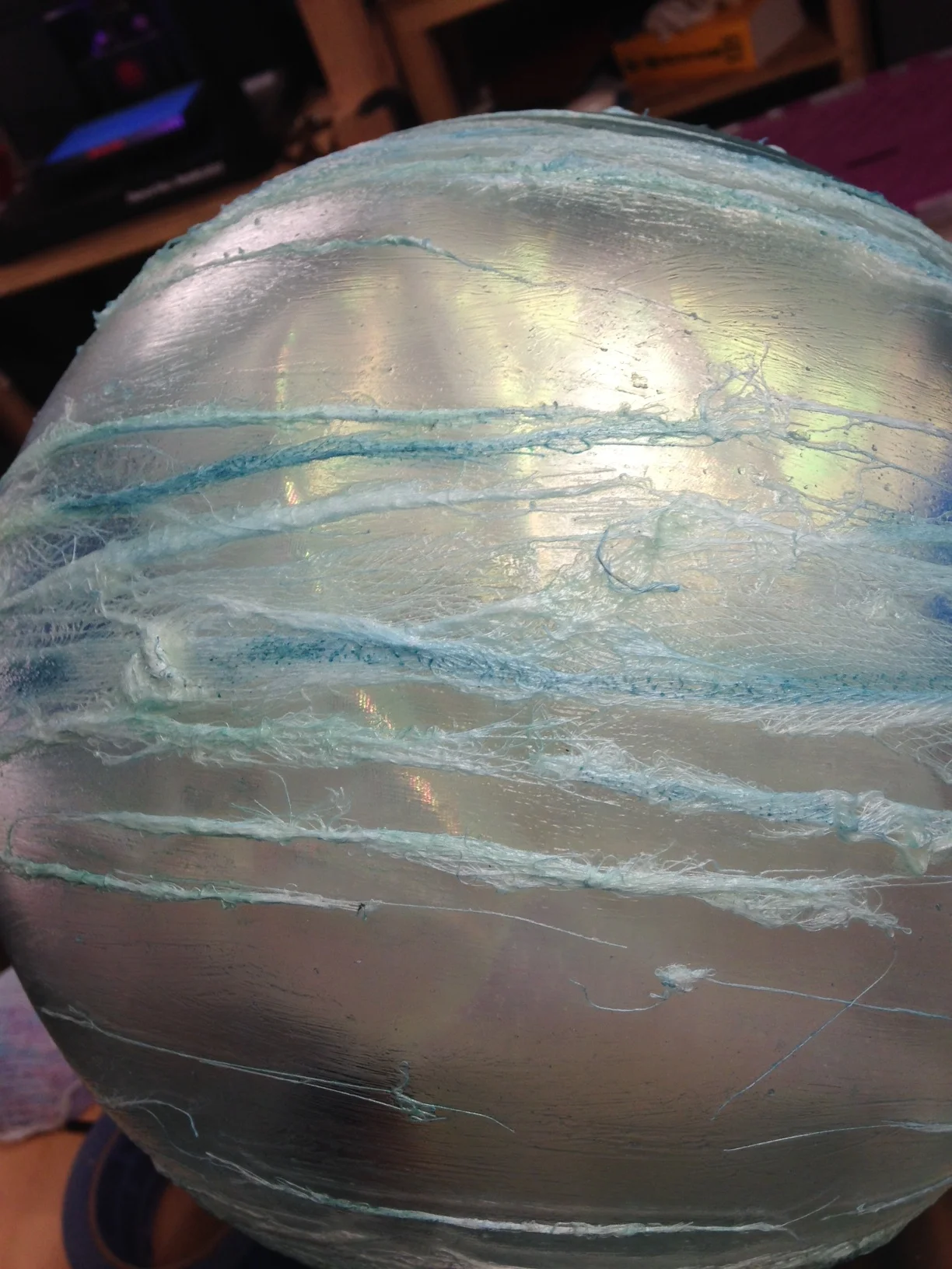  I then went in with an air brush and painted the cheesecloth with different hues of blue. This picture also has the ball filled with the iridescent fabric. 