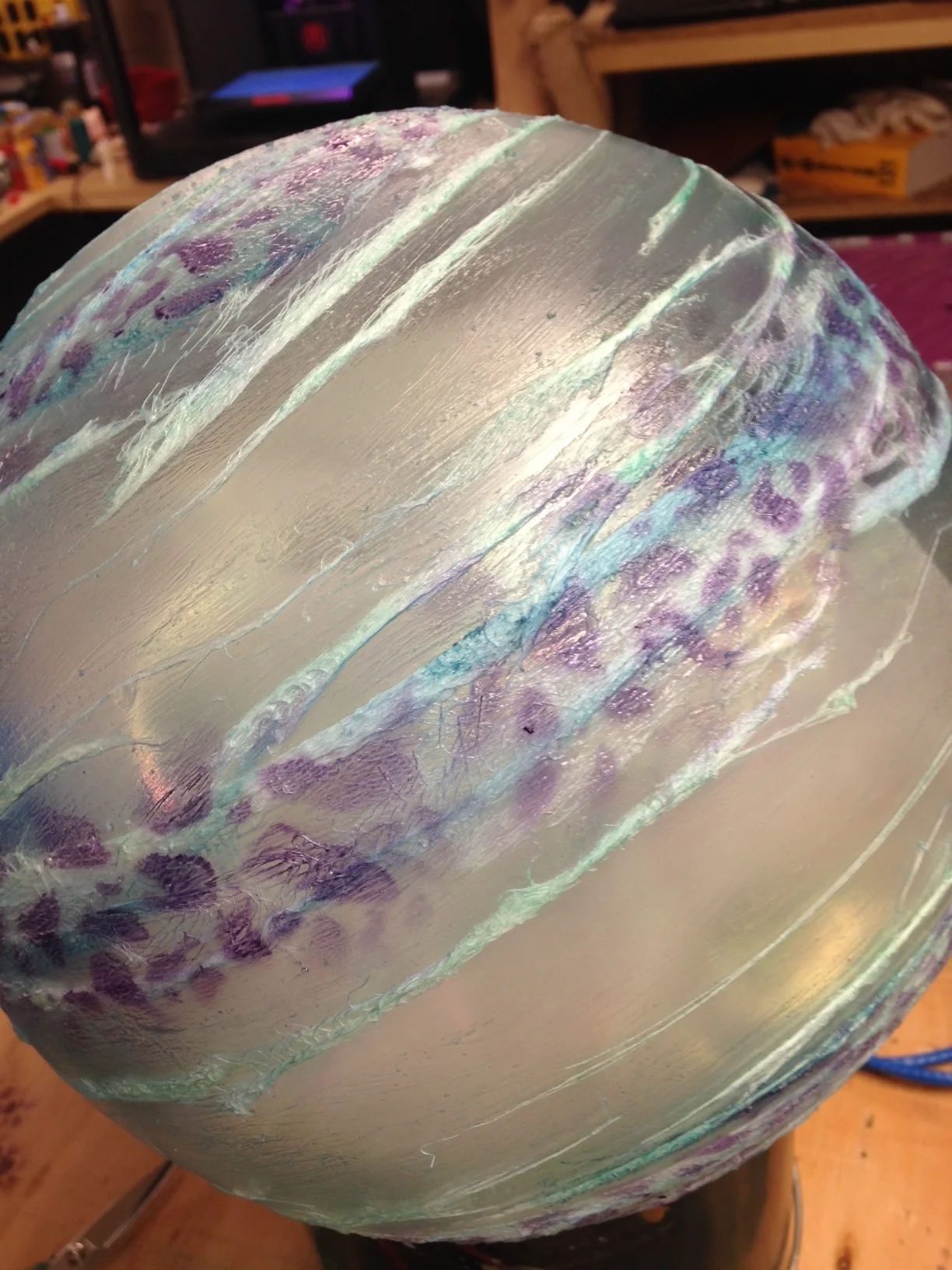  After the blue spirals, I went in with an airbrush with purple and a stencil to create the purple spots. The final eggs had the purple be less constricted to the original cheesecloth and faded more into the clear areas. 