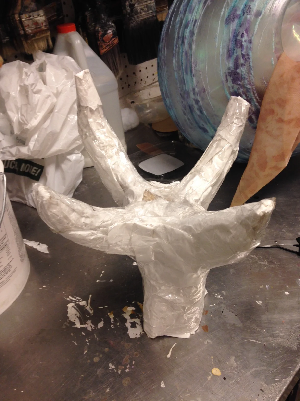  I created a dragon hand for the pedestal for the egg to sit on. I made a rough hand shape with plywood and covered it with paper and packing tape until I was happy with the shape. I then covered it with more Sculpt or Coat and cheesecloth before pai