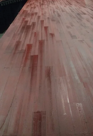  We created planks across with floor with a marker. The floor then got a dark glaze to create a hardwood floor effect. 