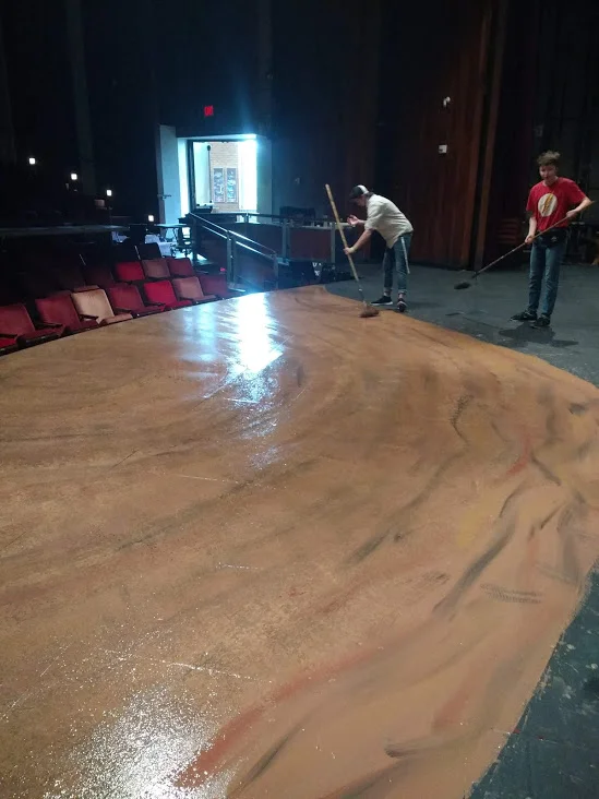  To paint the floor we based with a warm mud, then added streaks of red, dark brown and yellow. Then went over with a texture roller. Adding more dark color as we went further upstage. Finished with a spatter of all colors. 