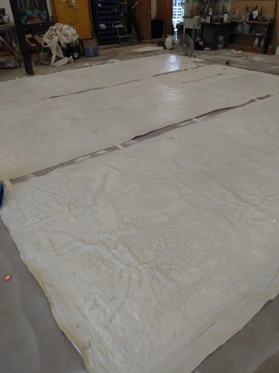  The full panels laid out, covered in glue, and sprayed white. 