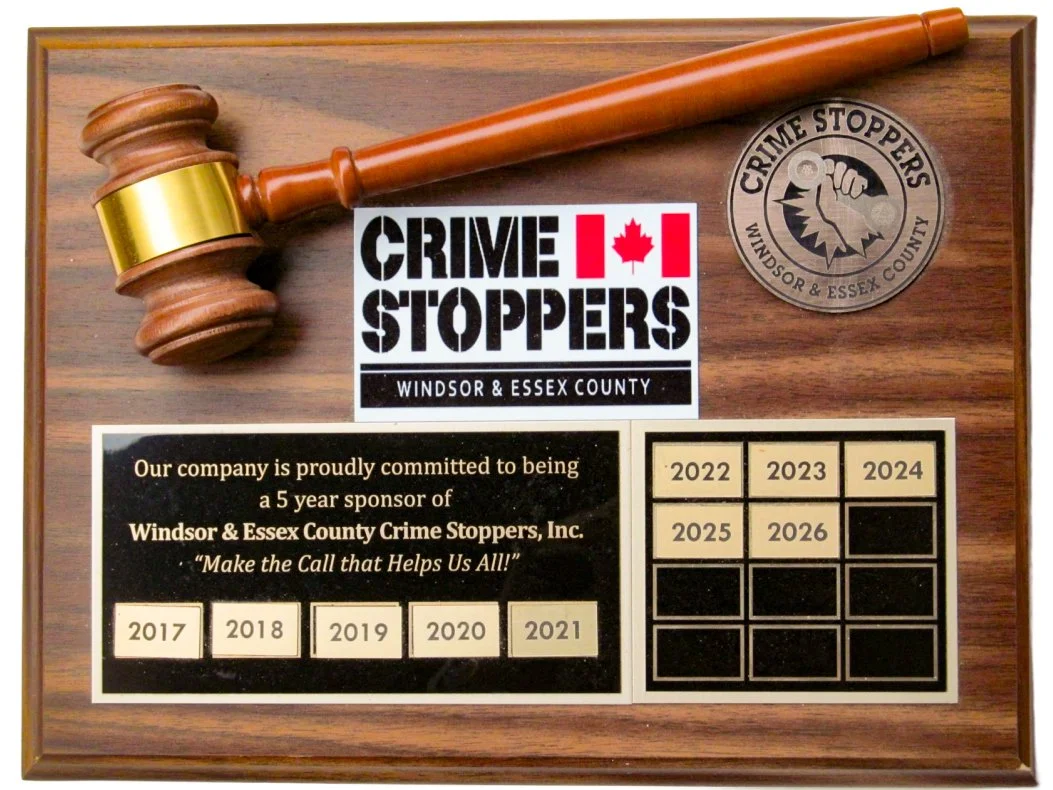 Wood plaque featuring a gavel, Windsor & Essex County Crime Stoppers logo, and a chart showing sponsorship years from 2017 to 2026.