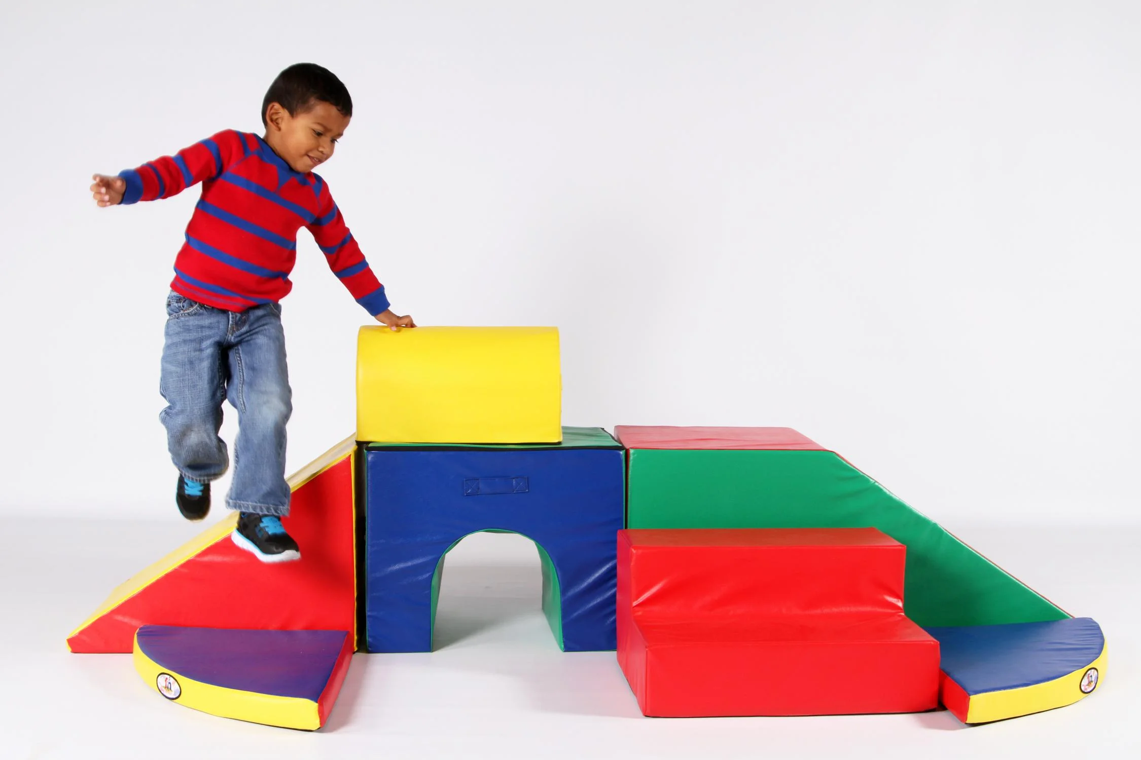 Preschool boy playing on Foamnasium foam play set. 