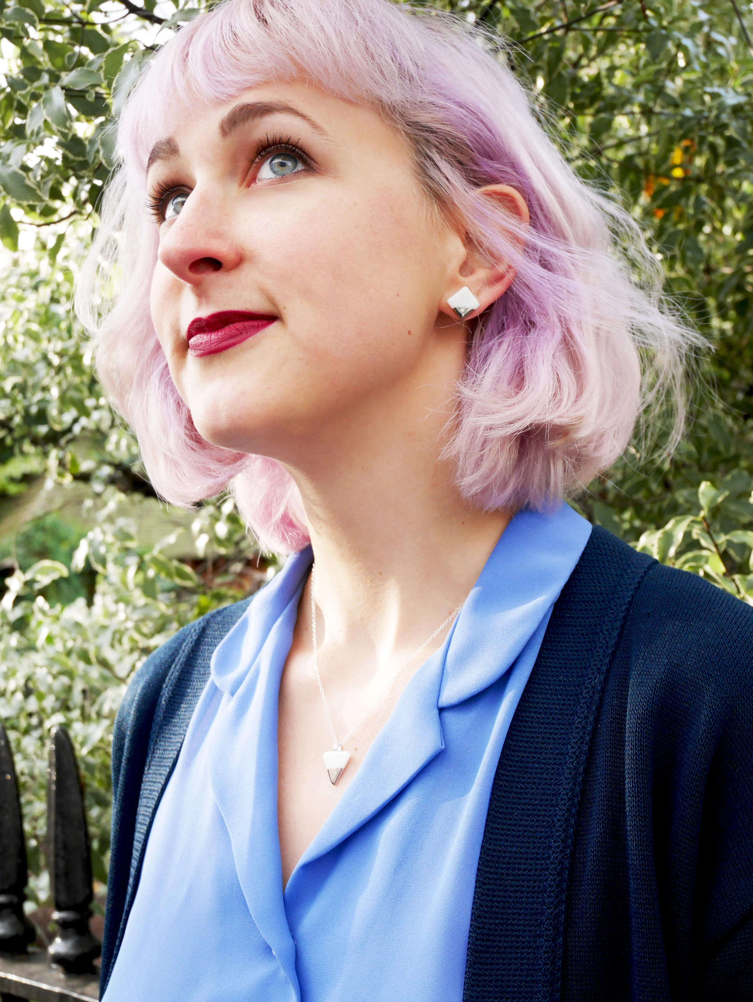 Model with lilac hair wearing porcelain pendant and earrings