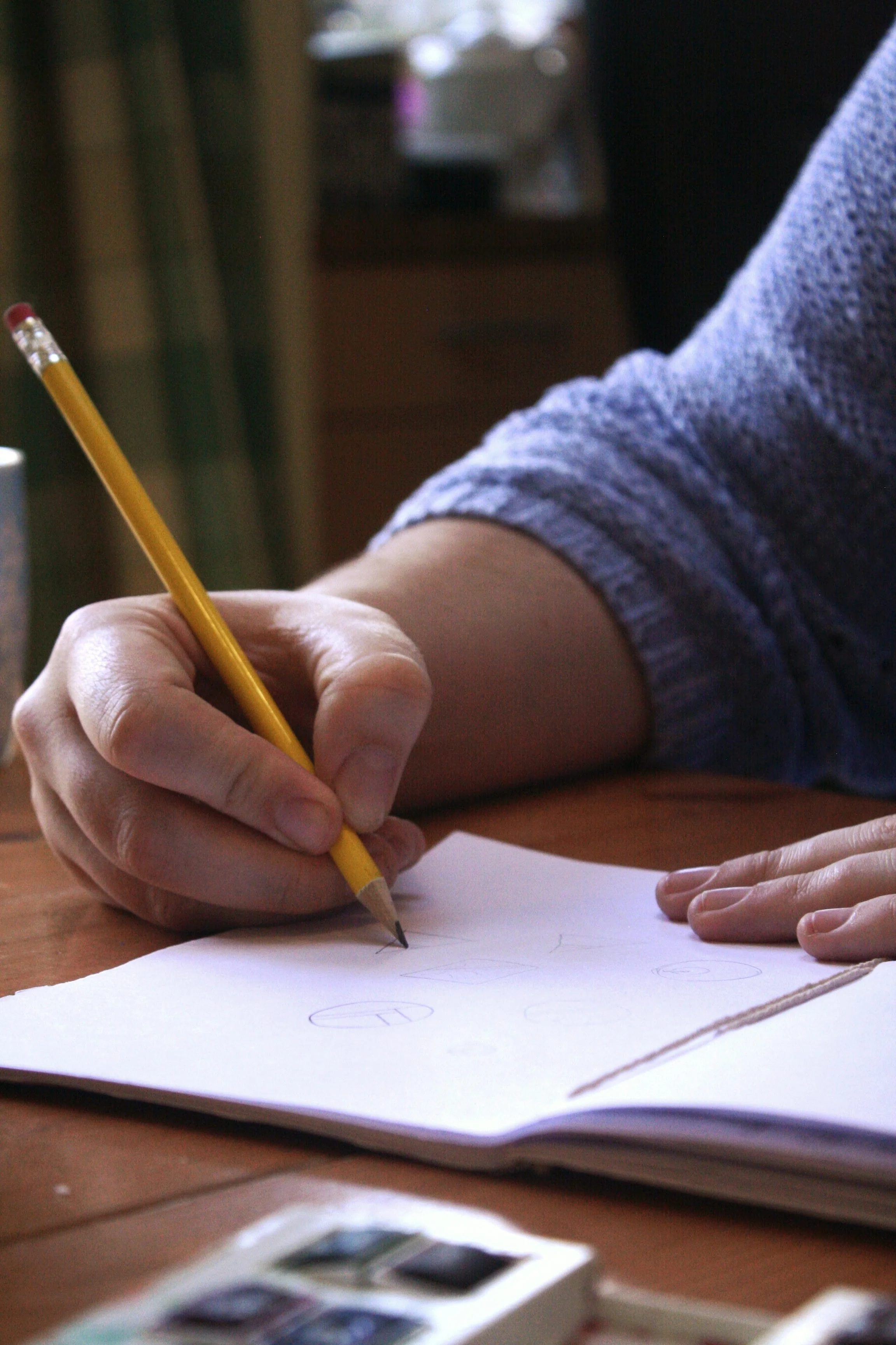 Suzanne drawing designs of her ceramic jewellery