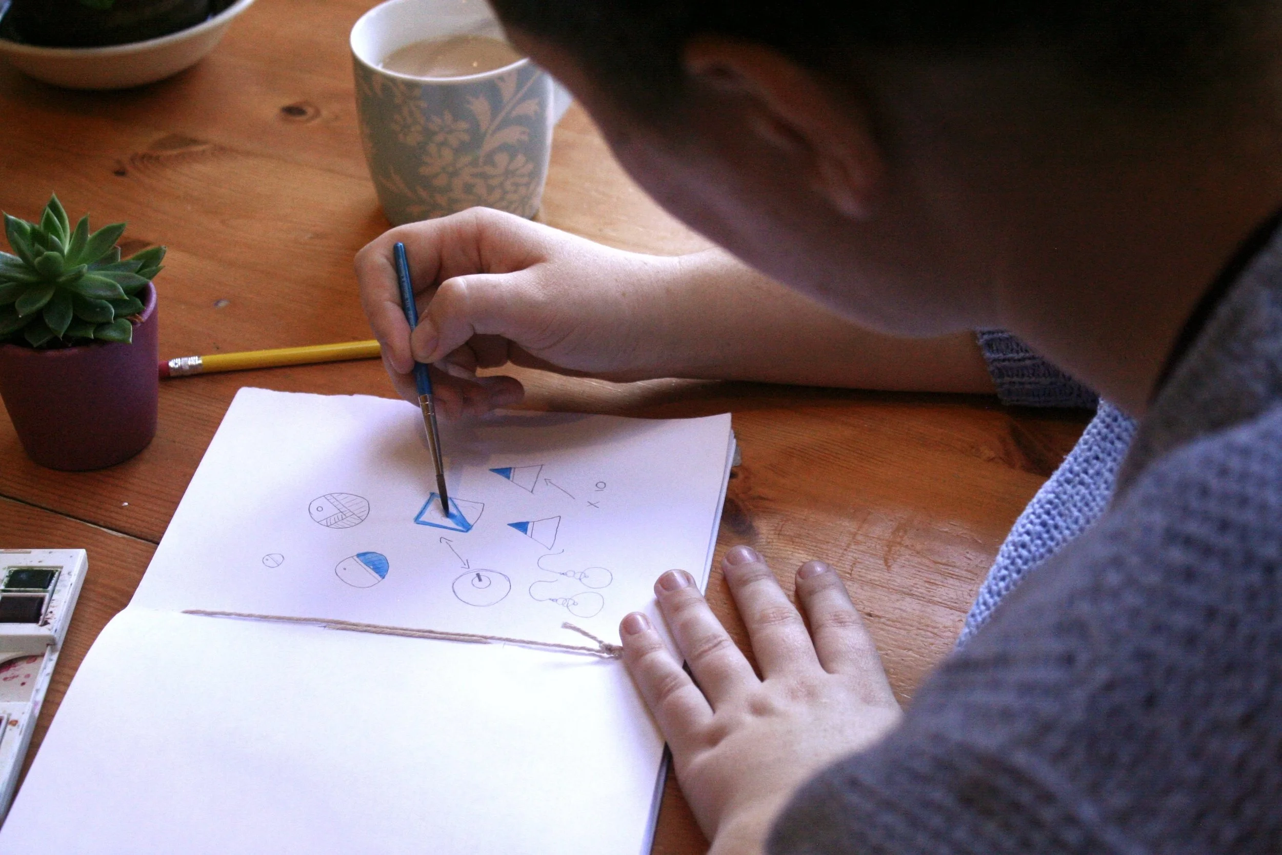 Suzanne designing the colour scheme for her pieces of ceramic jewellery