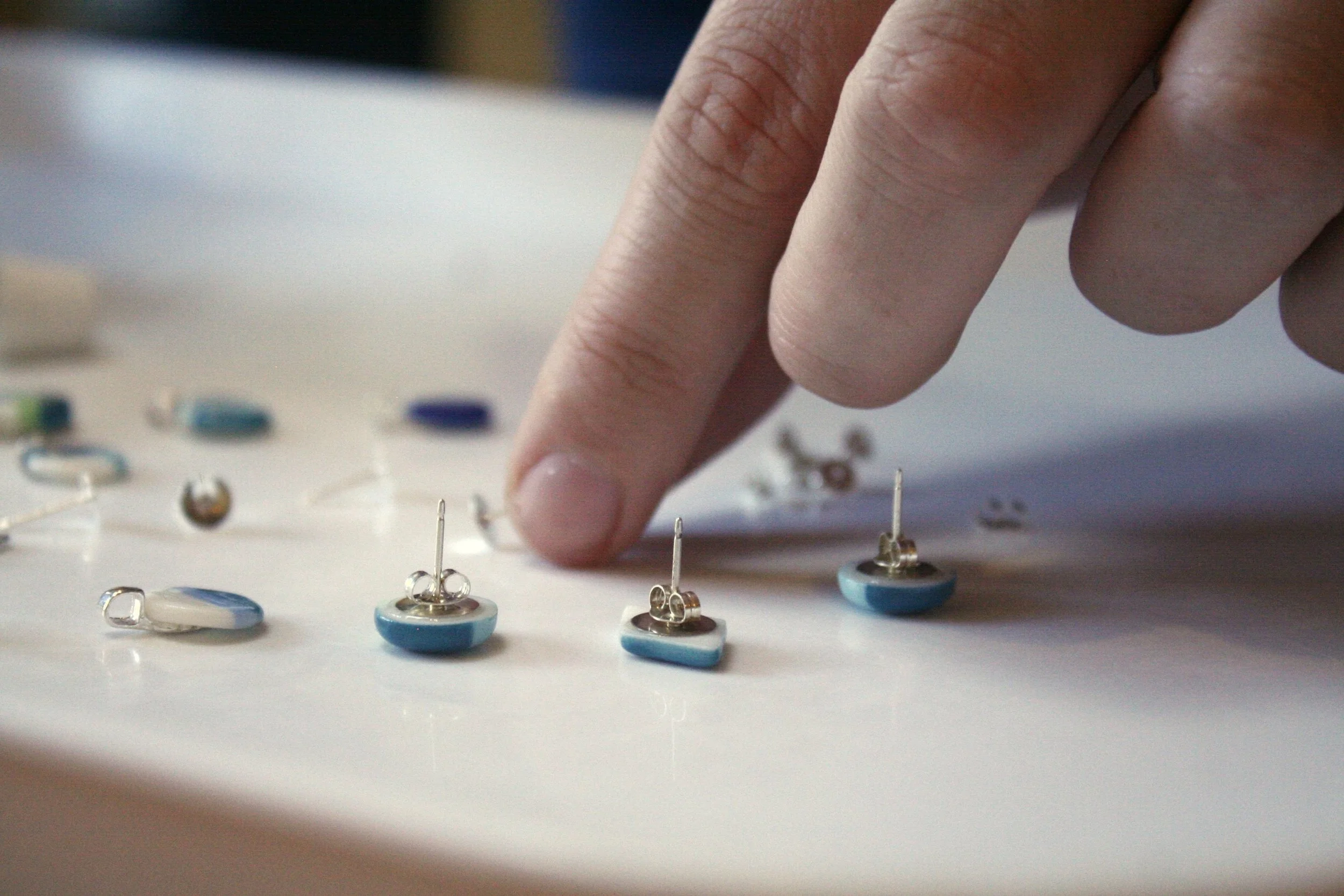 Adding silver to each handmade and painted ceramic earrings and pendants