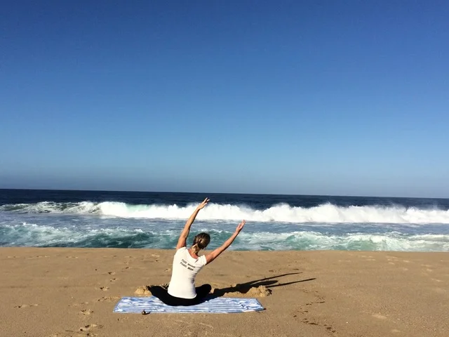 Kathleen Conklin doing yoga on the beach