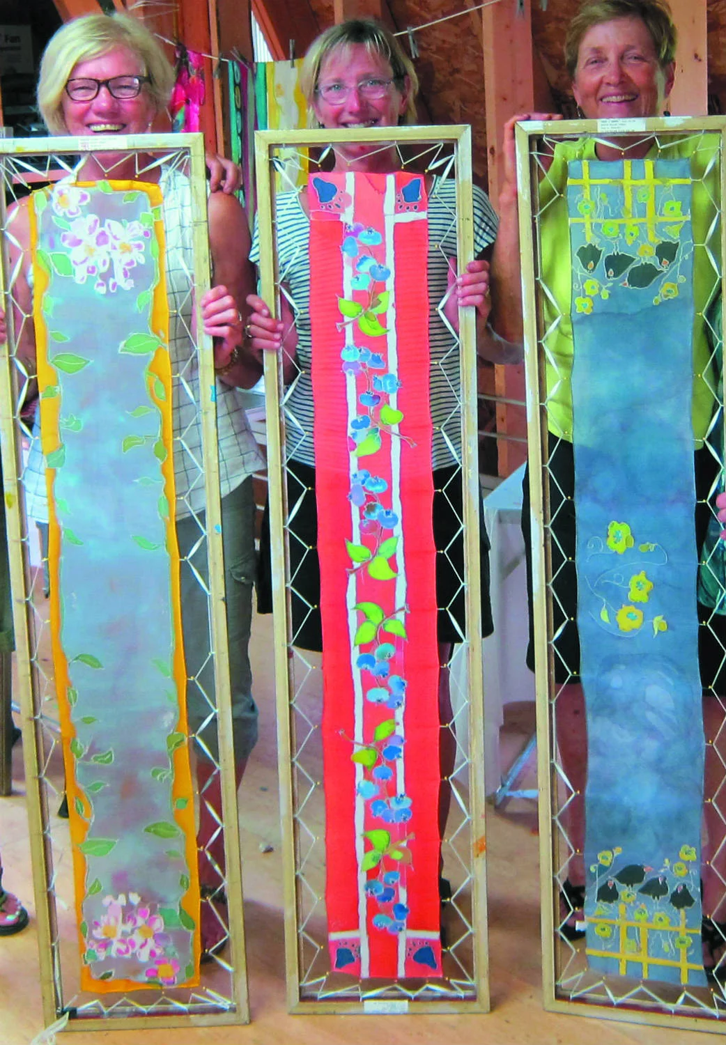 Silk painting students displaying finished work