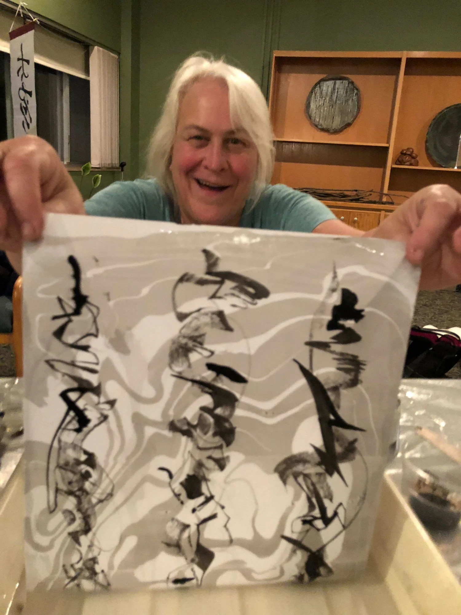 Retreat attendee showing artwork at Peter Fraterdeus and Kate Miller retreat