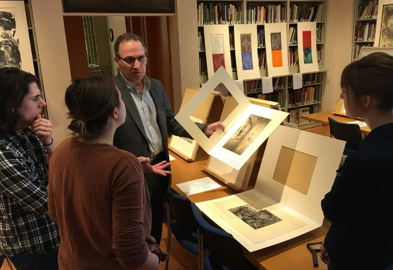 Sam Orosz, Amira Pualwan, and Makenzie Flom visit with Dennis Michael Jon (facing camera), Senior Curator of Prints and Drawings at Mia. 