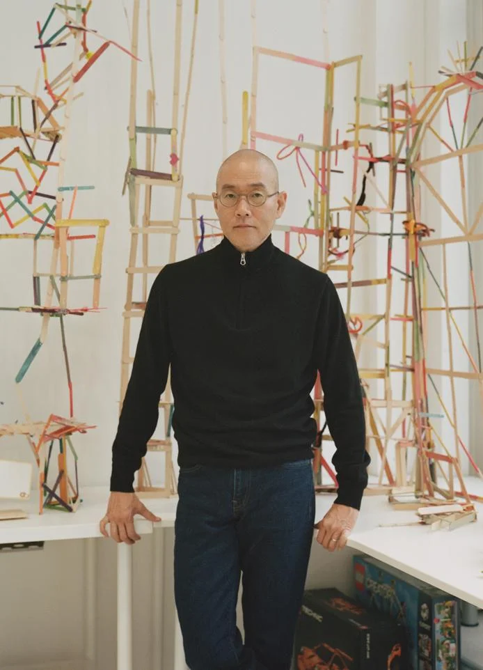 Artist Do Ho Suh, at his London studio, in front of Happy Holiday Weekend Making Machine (2015-present), created with his daughters Aami and Omi. Photography: Johnnie Shand Kydd