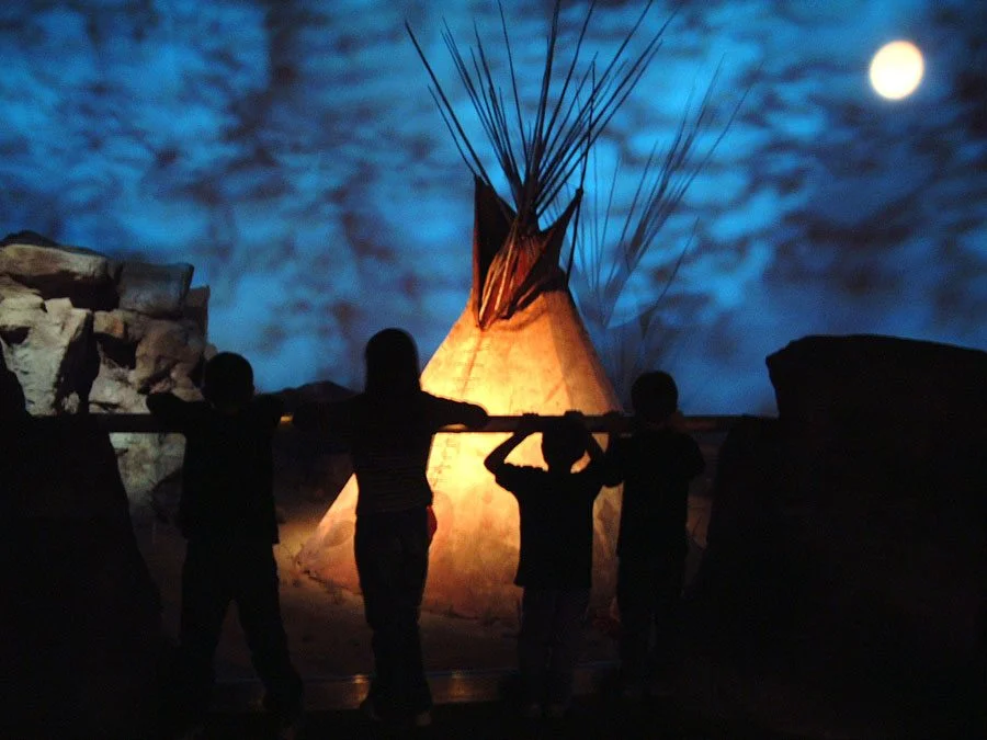 Visitors in silhouette in front of the “Seasons of Life” gallery in the Plains Indian Museum. Photo credit centerofthewest.org
