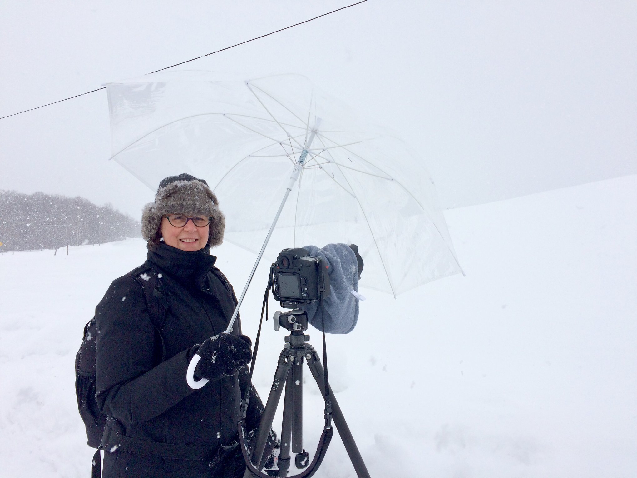 Teamwork: I am holding an umbrella over Ulana's camera in order to keep the blowing snow off her lens.