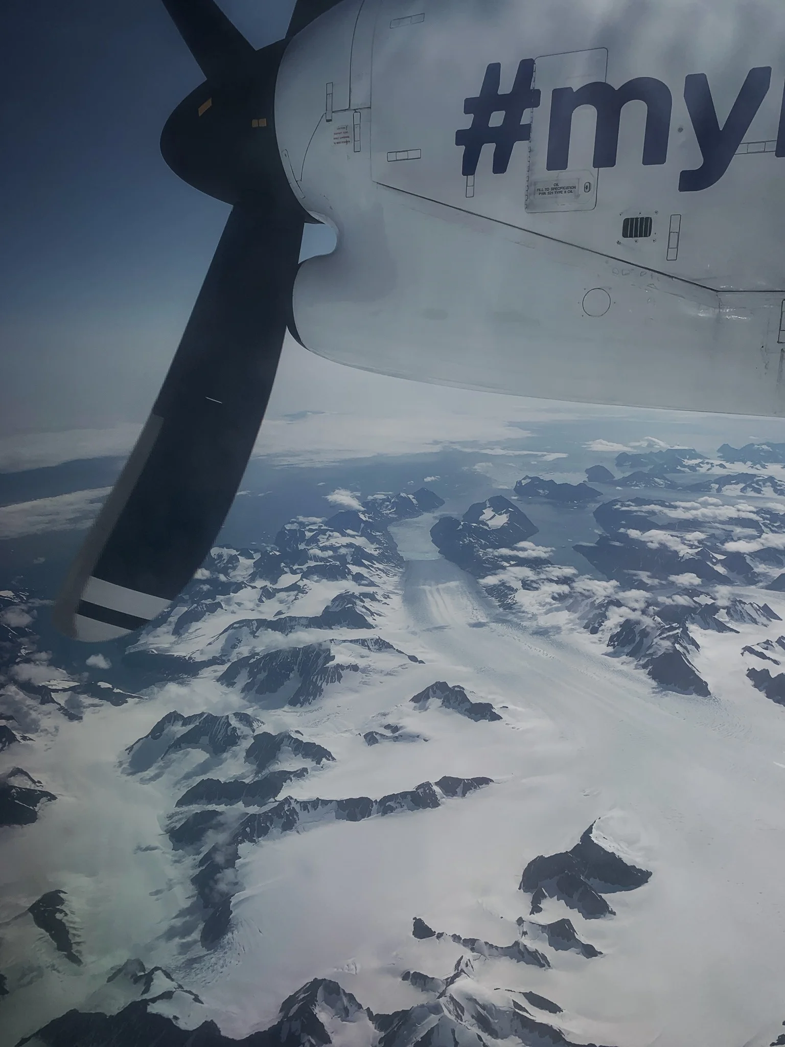 A massive glacier pours off the Greenlandic coast: a last sight of this amazing place.