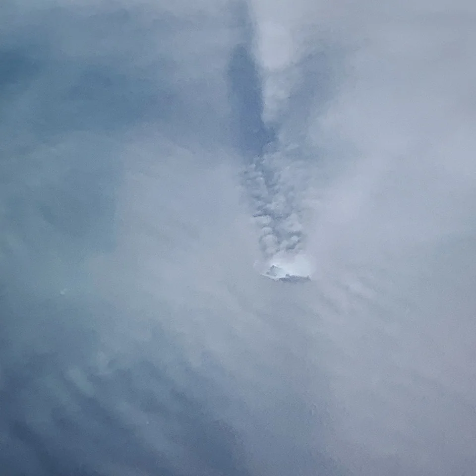Not a great shot, but this is the last iceberg we saw from the air, off the east coast of Greenland. Notice how the clouds have parted around it - how the iceberg is making its own little weather system.