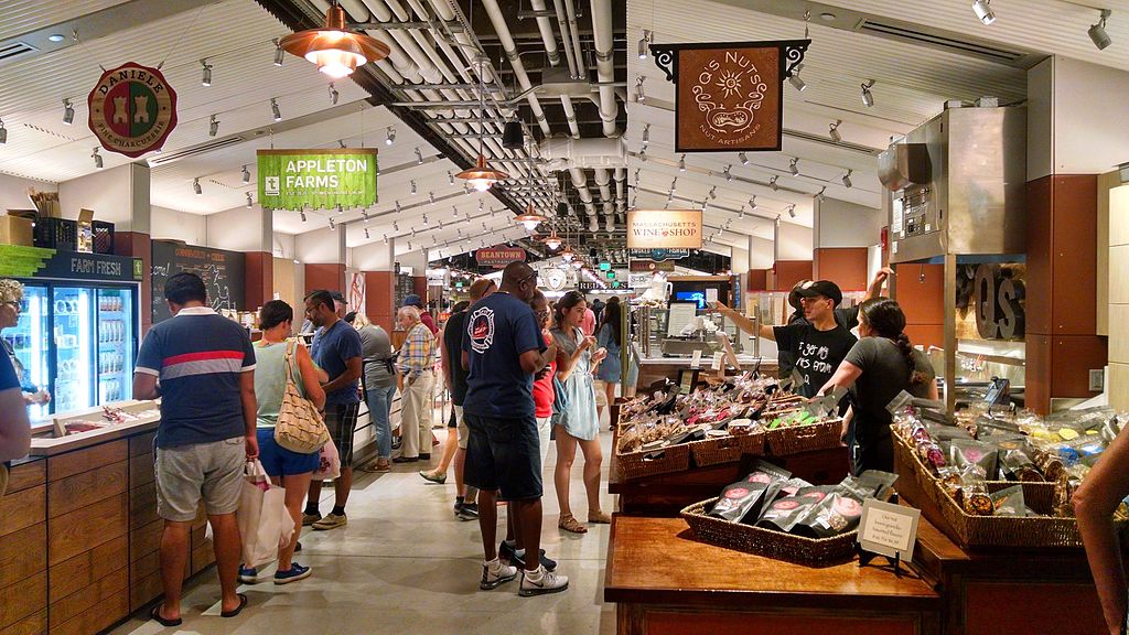 Customers viewing the selection of goods and foods inside Boston Public Market