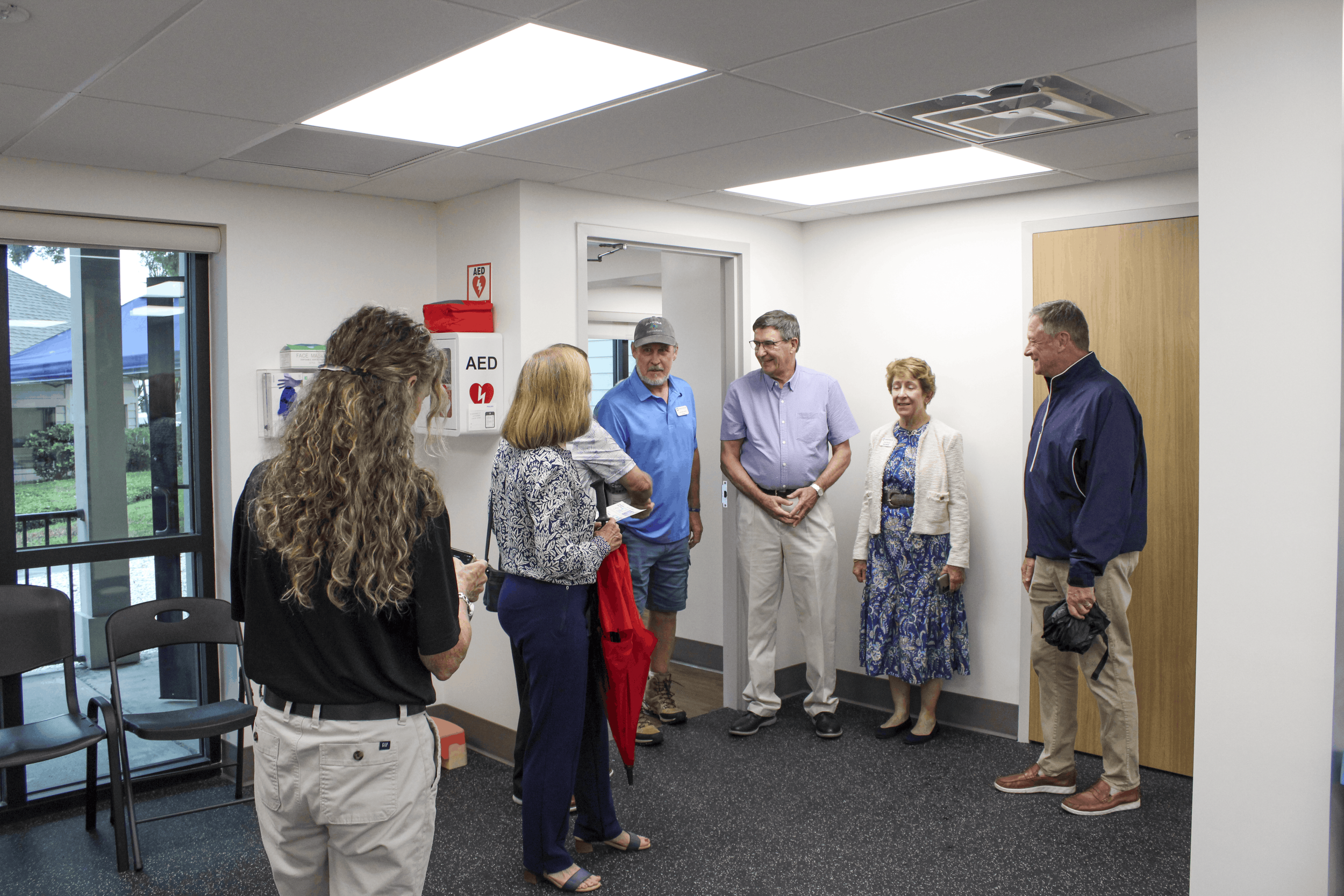 Guests gather and talk during a tour inside the Wellness Center.
