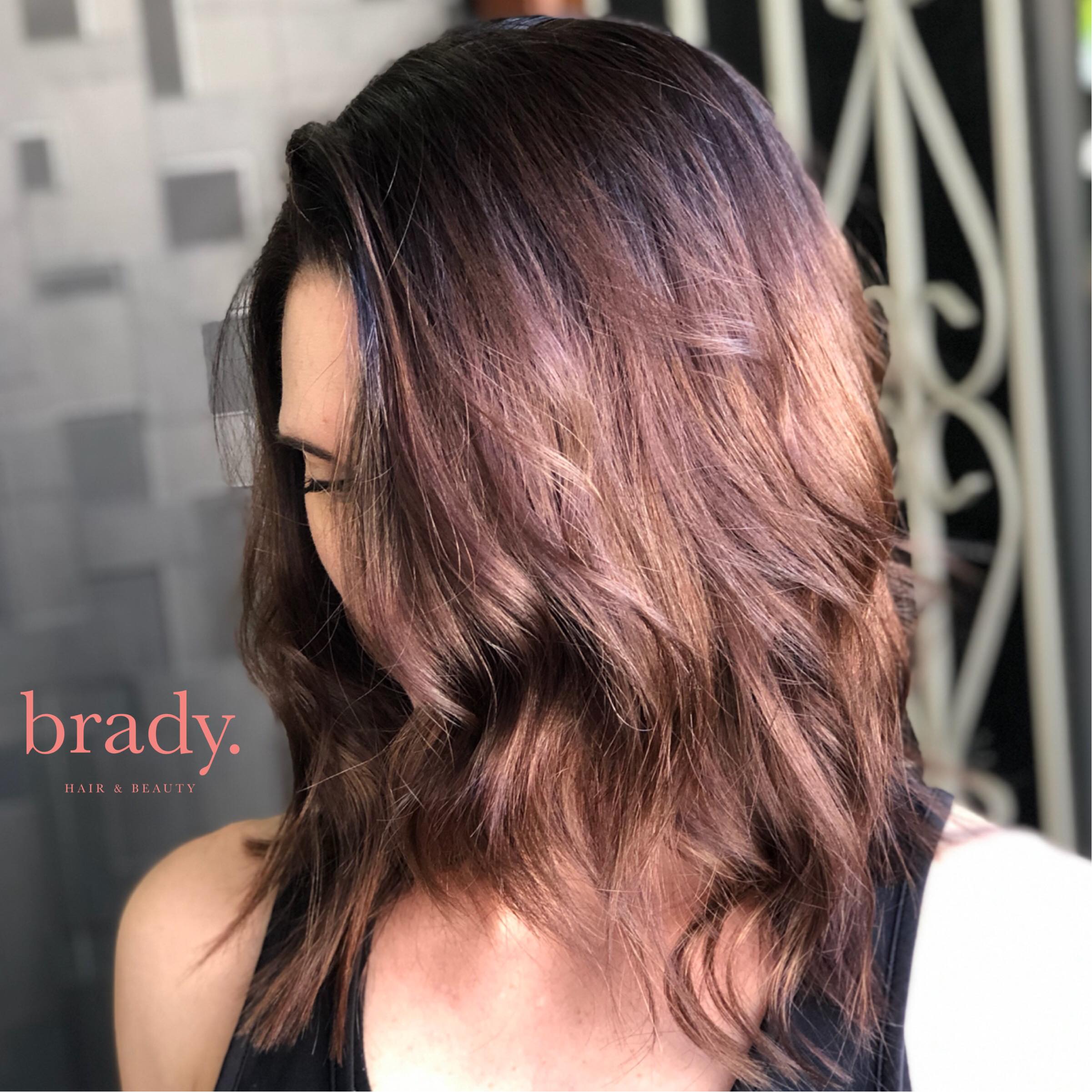  Photo of woman with medium-length wavy brunette hair, styled by Brady. Hair &amp; Beauty, Toowong, Brisbane. 