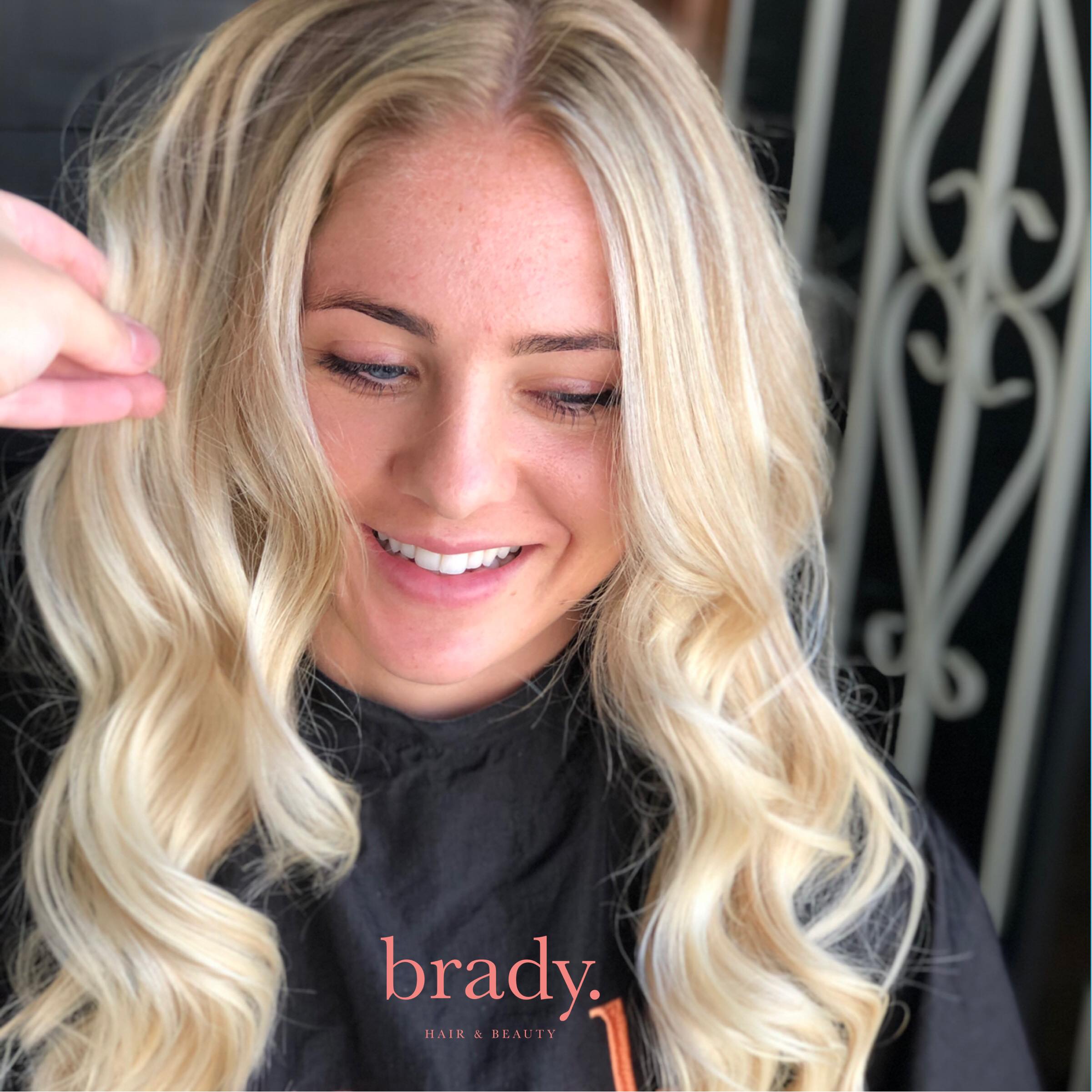  Photo of woman with long wavy blonde hair, styled by Brady. Hair &amp; Beauty, Toowong, Brisbane. 