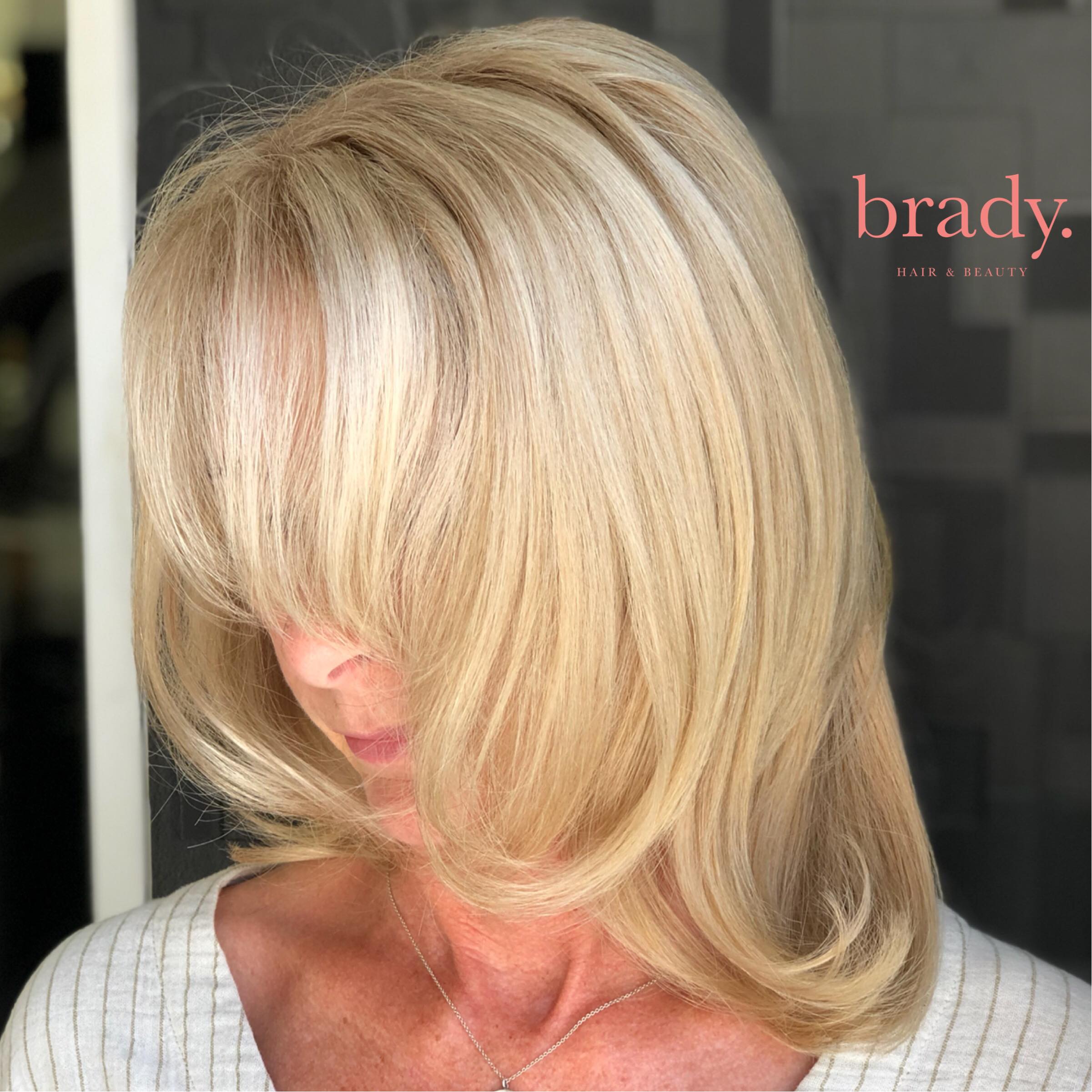  Photo of woman with soft, shoulder length blonde hair, styled by Brady. Hair &amp; Beauty, Toowong, Brisbane. 