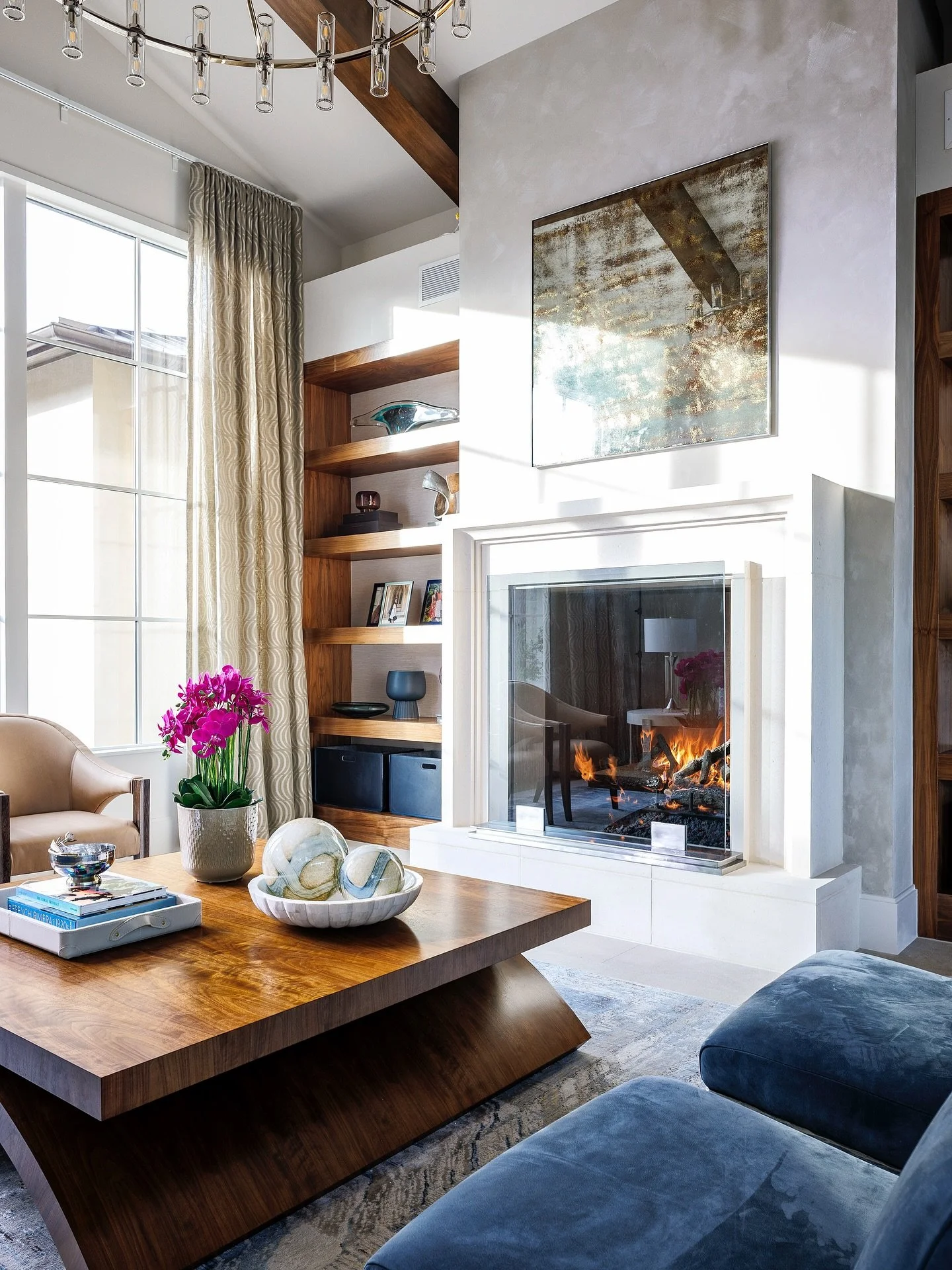 Walnut, suede, limestone, plaster, antique mirror, and soft textures layered together for a cozy space in our living room. #InteriorDesignInspo #homedesignideas #functionaldesign #dreamspaces #interiorstyling #cozyhome #homedecorideas #atxinteriors #