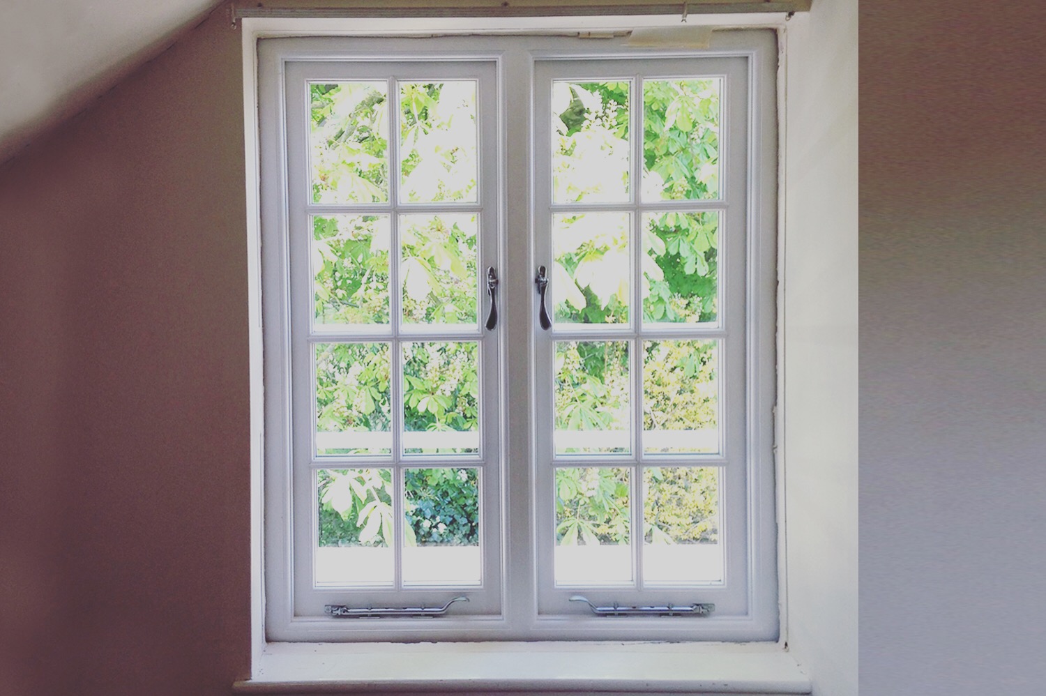 The 8-pane sashes in this Cambridge home were in very poor condition but the frame was ok. We replaced with like-for-like sashes which frame the garden beautifully.