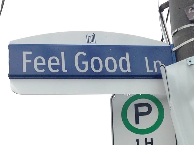 STRESS RELIEF STREET SIGN REMINDS US TO HAVE A "FEEL GOOD LANE"