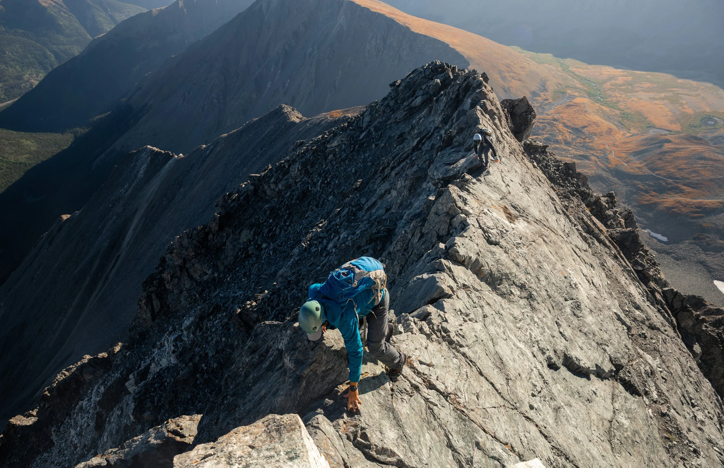 Climbers scramble across the exposed knife-edge section of Kelso Ridge