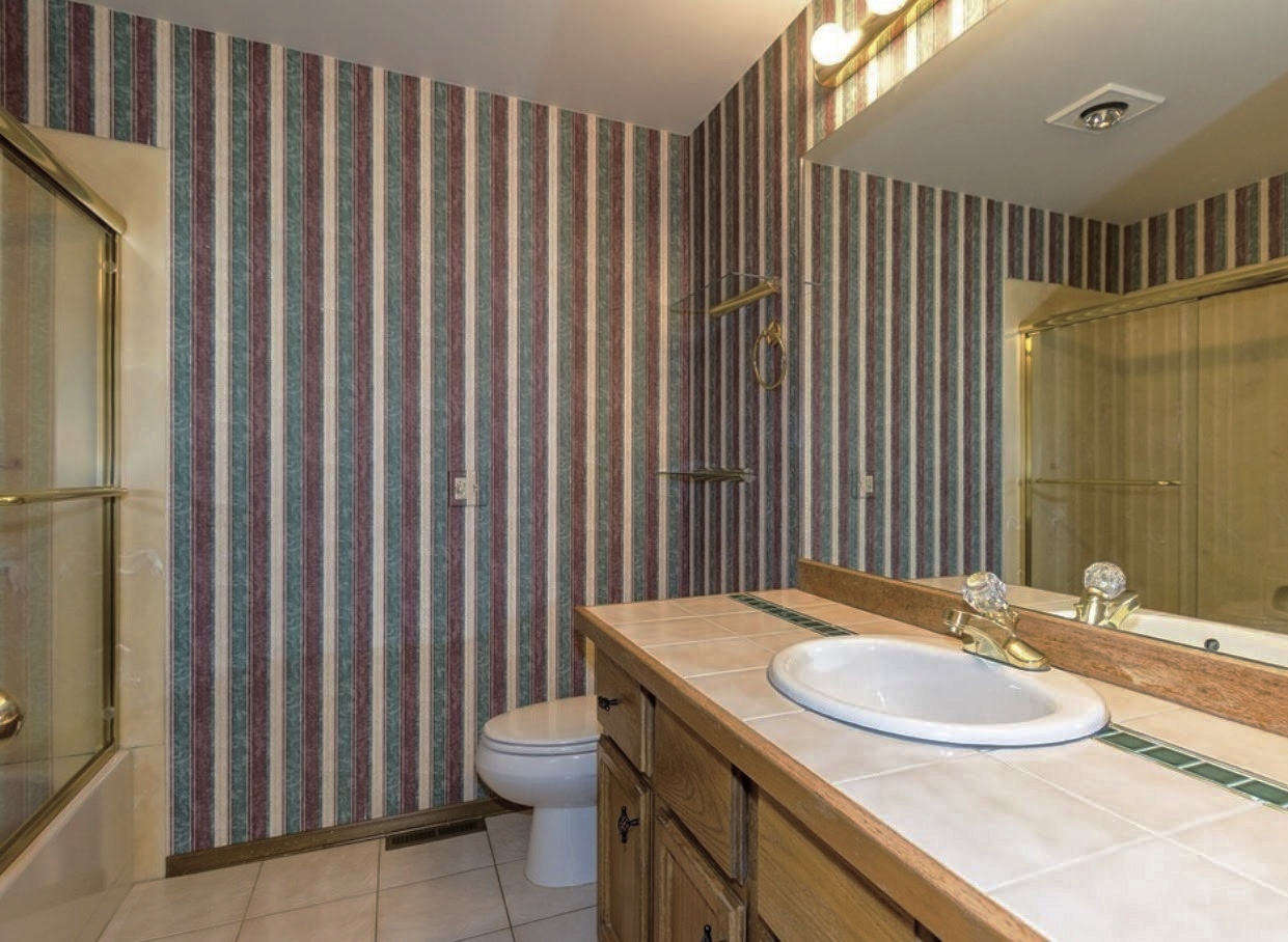Hallway bath. The bathroom door was wallpapered too so when it was closed it felt like you were trapped inside with no exit. 
