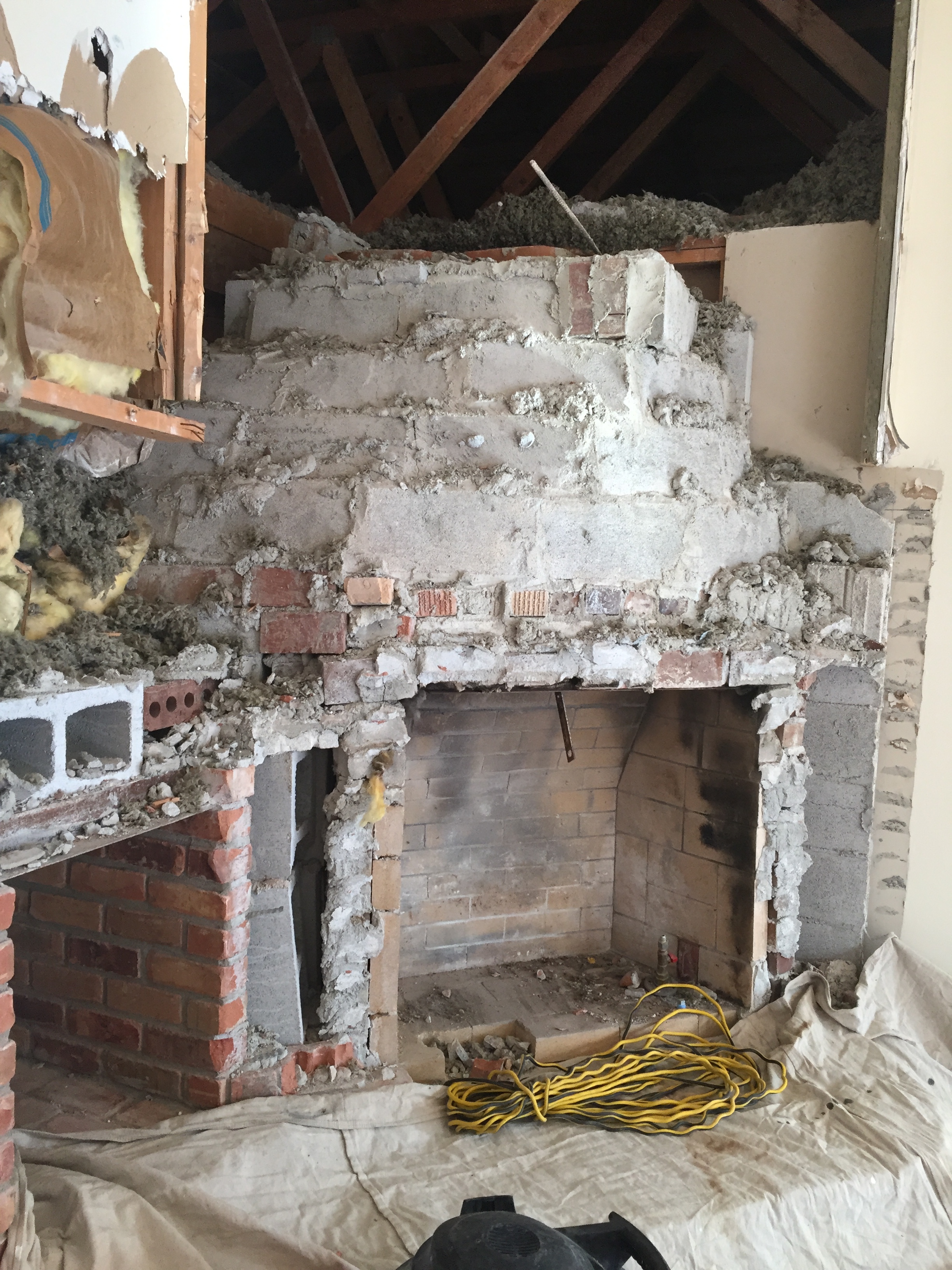 After taking it down more we decided to take out the whole thing! These fireplaces were a mess! So so much brick and concrete. 