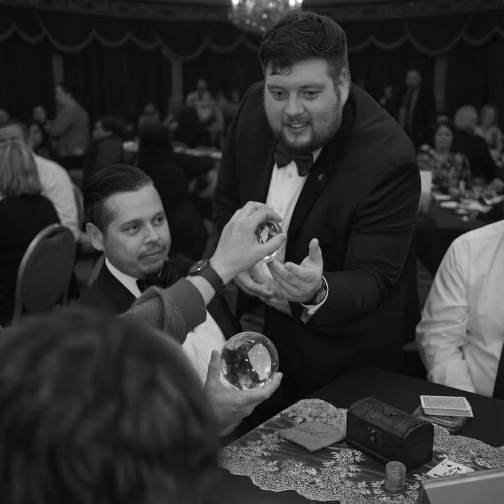 Close-up magician performing table magic with props at Orange County wedding reception dinner
