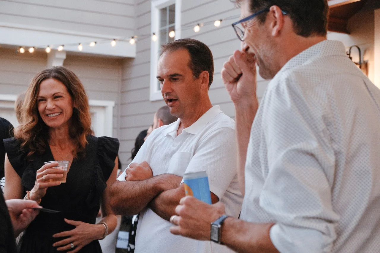 Corporate event guests watching professional close-up magician perform at Orange County private party