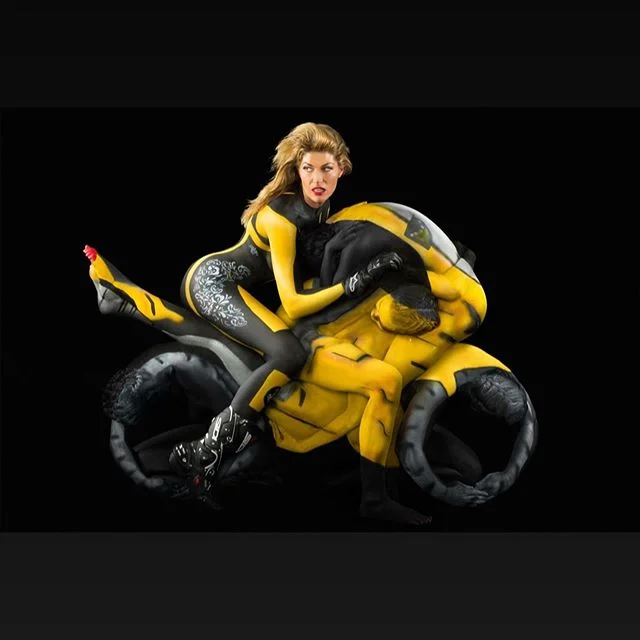 Cooperation, balance and working as a team is essential to our multi-body human sculptures.  Using multiple bodies &amp; bodypaint, we compose a singular sculpture- many become one, working together, to achieve a common goal.  In these artworks, a single perspective point is used to draw the eye towards a moment of perfected illusion.  Whether created live as a performance, for a viral video or &ldquo;double take&rdquo; imagery, there&rsquo;s no denying the pop dynamism of these optical illusion human sculptures.