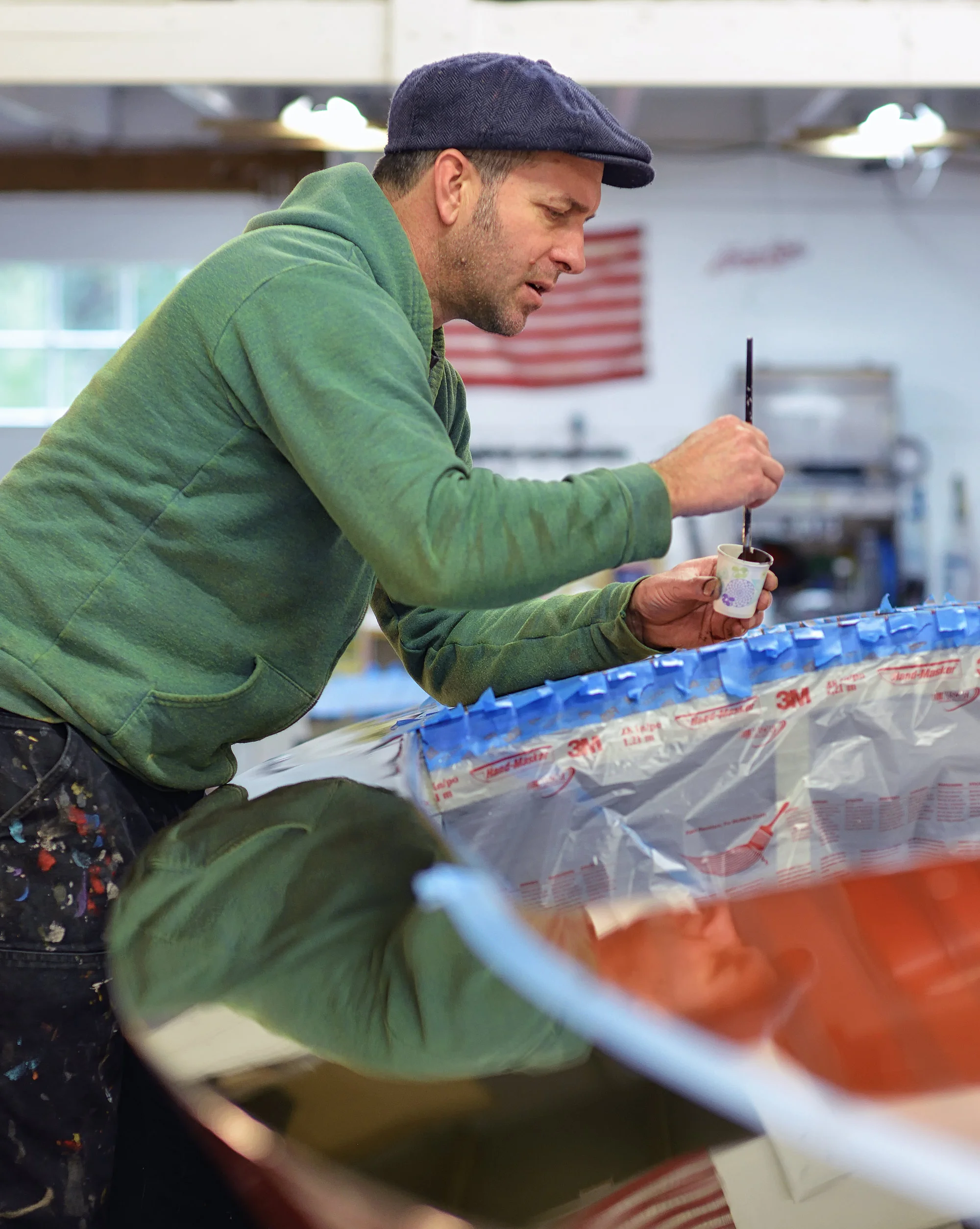 Justin applying the pinstriping to Grandy (above) at LO Boat