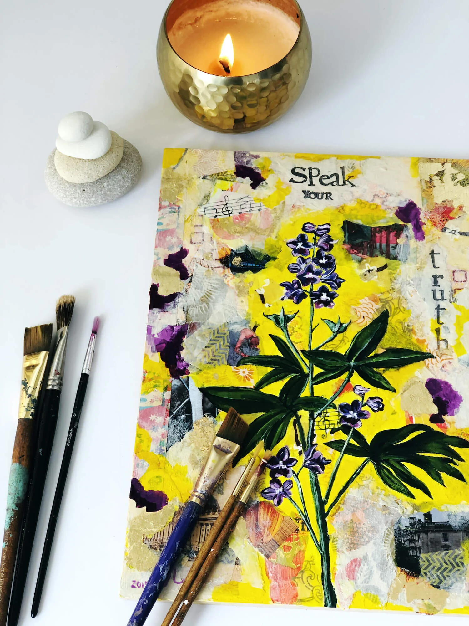 A gold candle, pebbles and a mixed media painting - a quiet corner from the studio