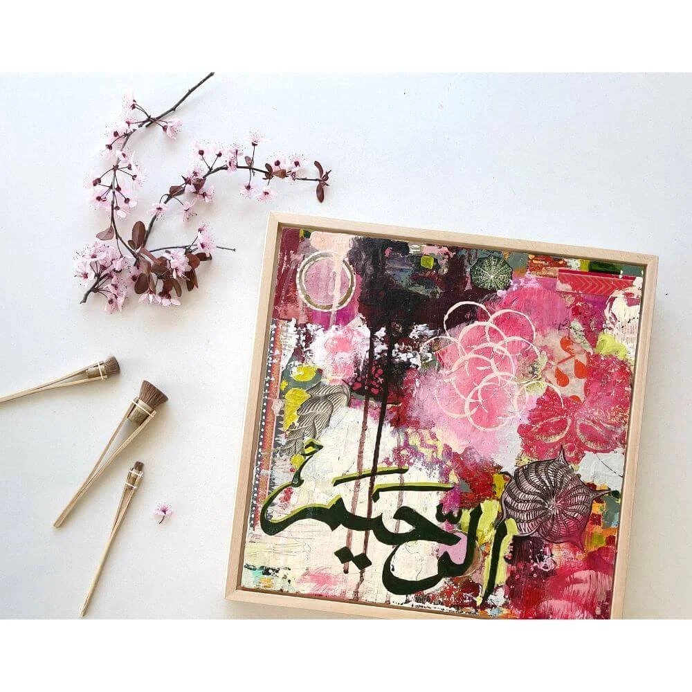 Compassion, framed mixed media painting depicting the Name Al-Rahim, on panel from the Hu Collection, styled in a flatlay with cherry blossom branches and paintbrushes