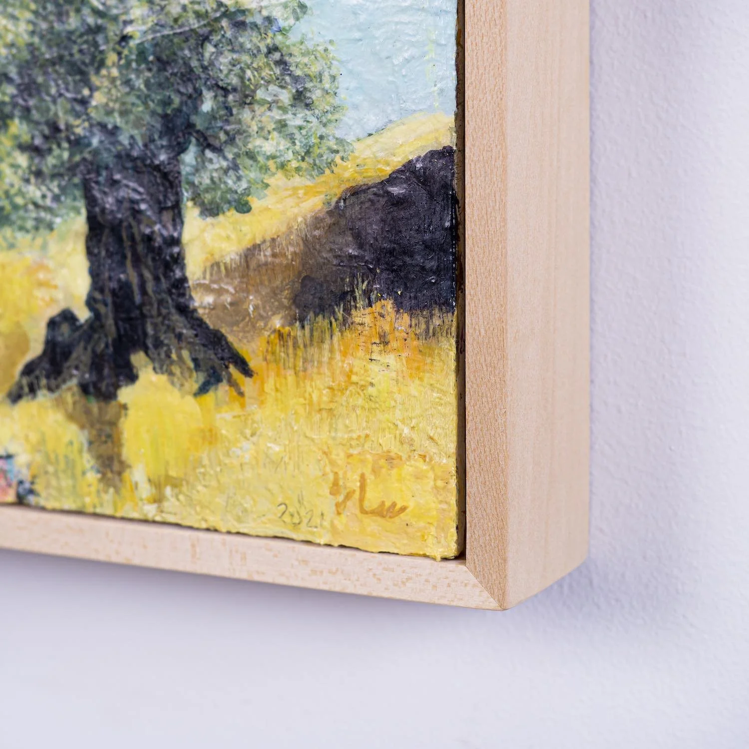 Close-up of a birch panel frame corner on Balmy Meadow, an olive tree painting from the Hu Collection, signed and dated 2021, by Sara Kabariti