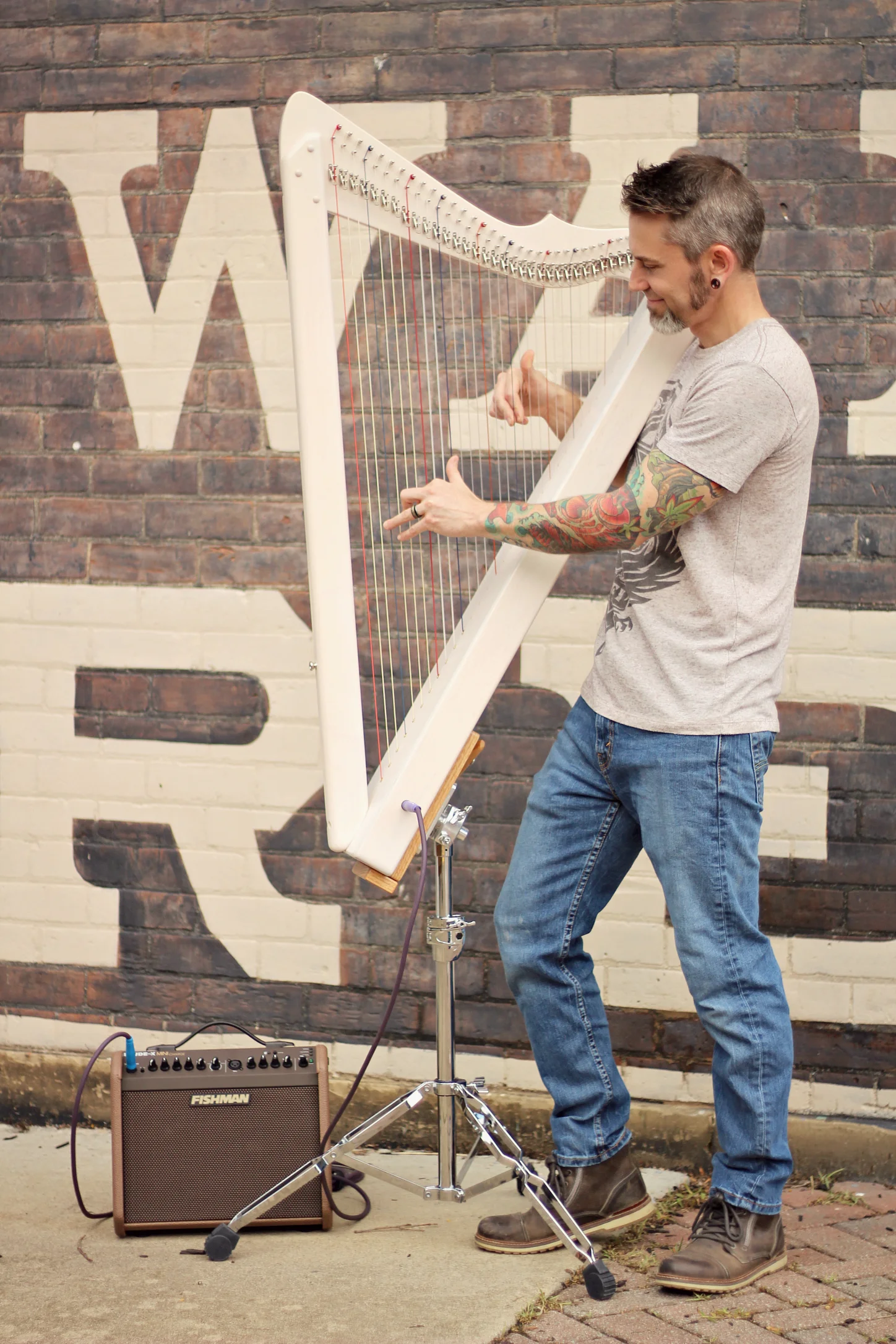 Garen using a Fishman Loudbox Mini Charge Amp, Asterope Hi Def Cable, a Grand Harpsicle® Harp and a Grand Standing Stand.