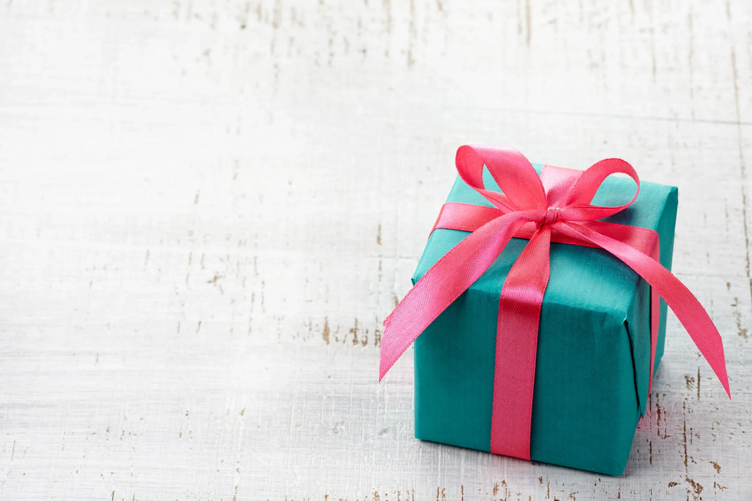 Gift box tied with a pink ribbon.webp