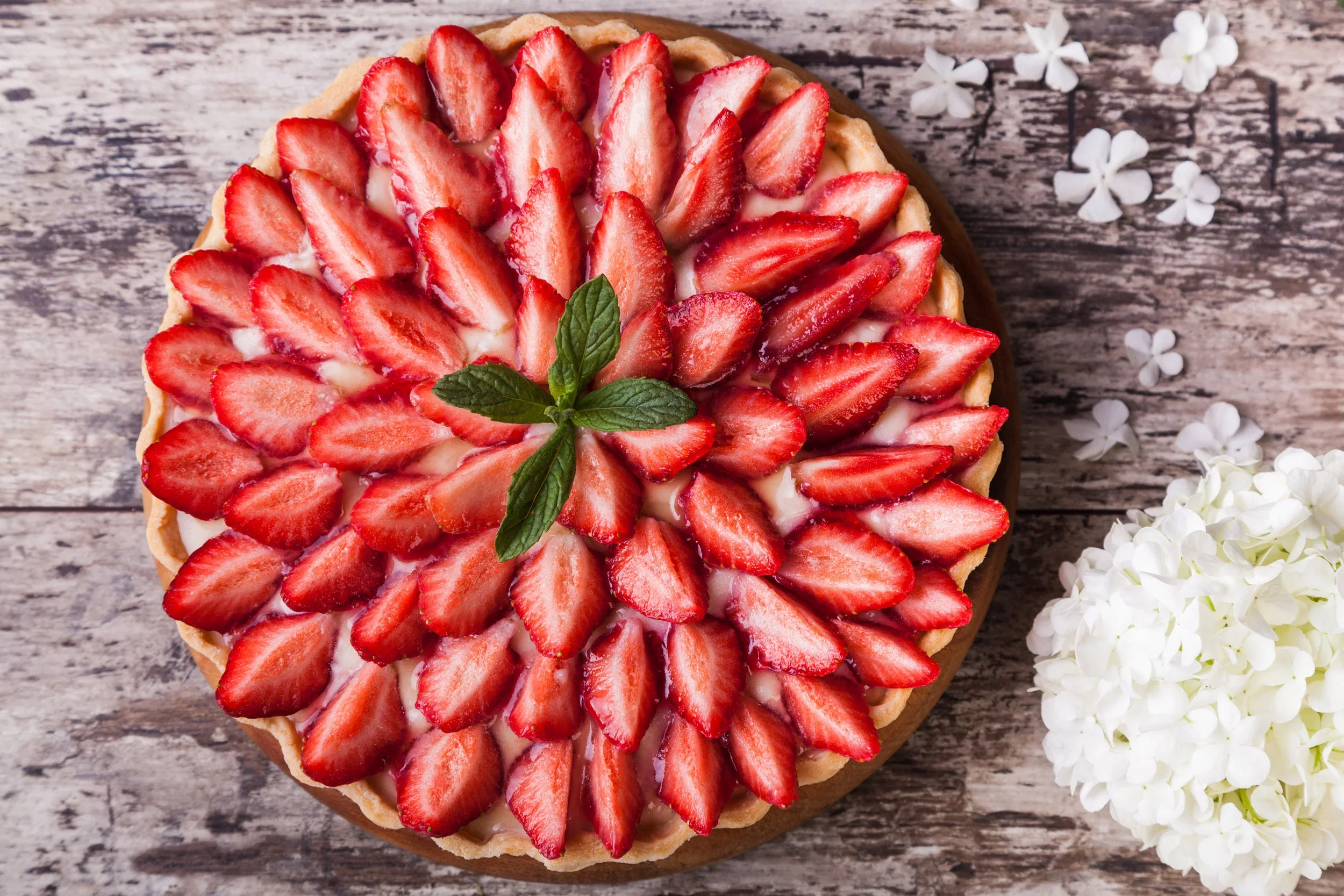 Strawberry tart topped with fresh mint.webp
