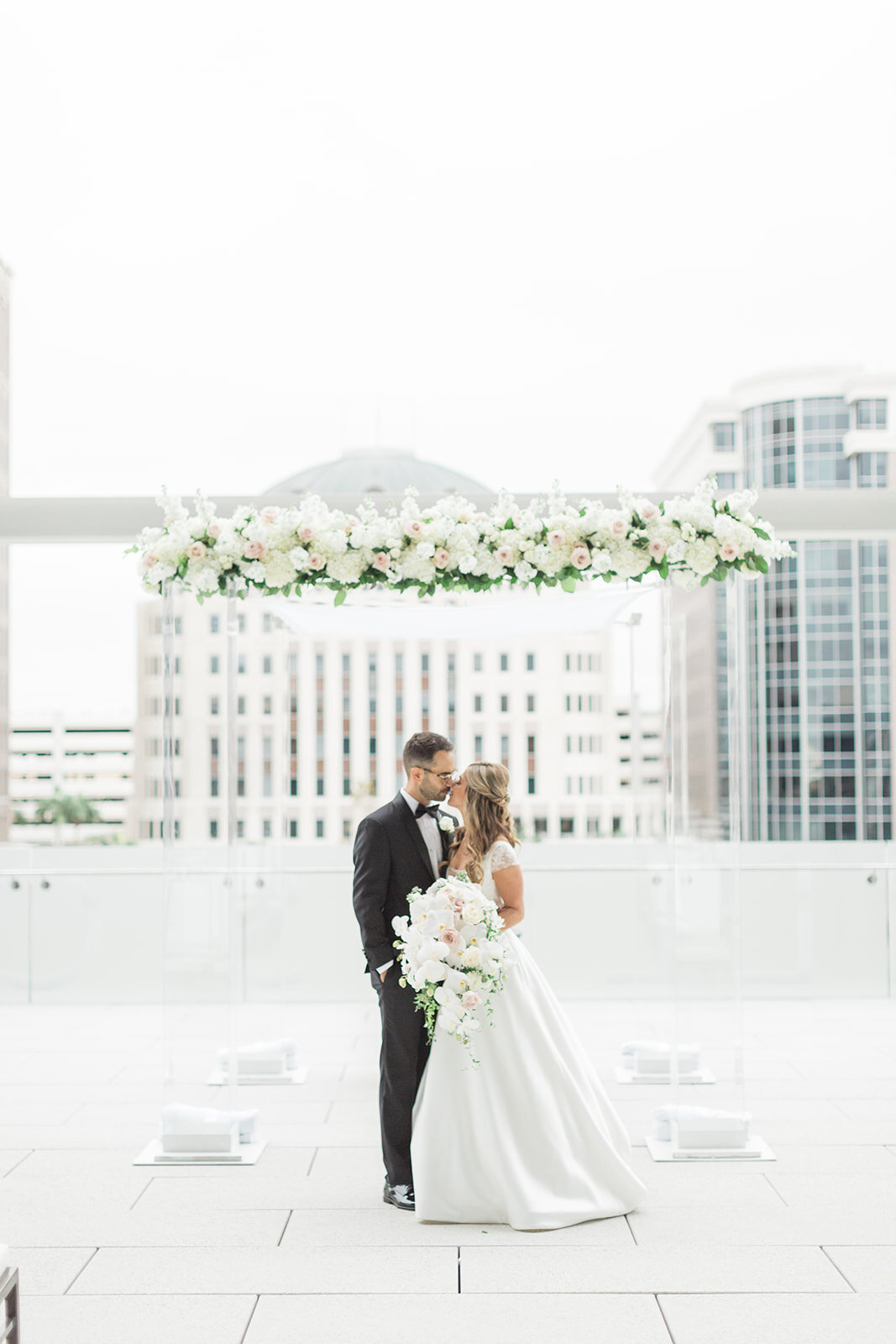 Fairbanks Florist Chuppah Bride Groom Kiss.jpg