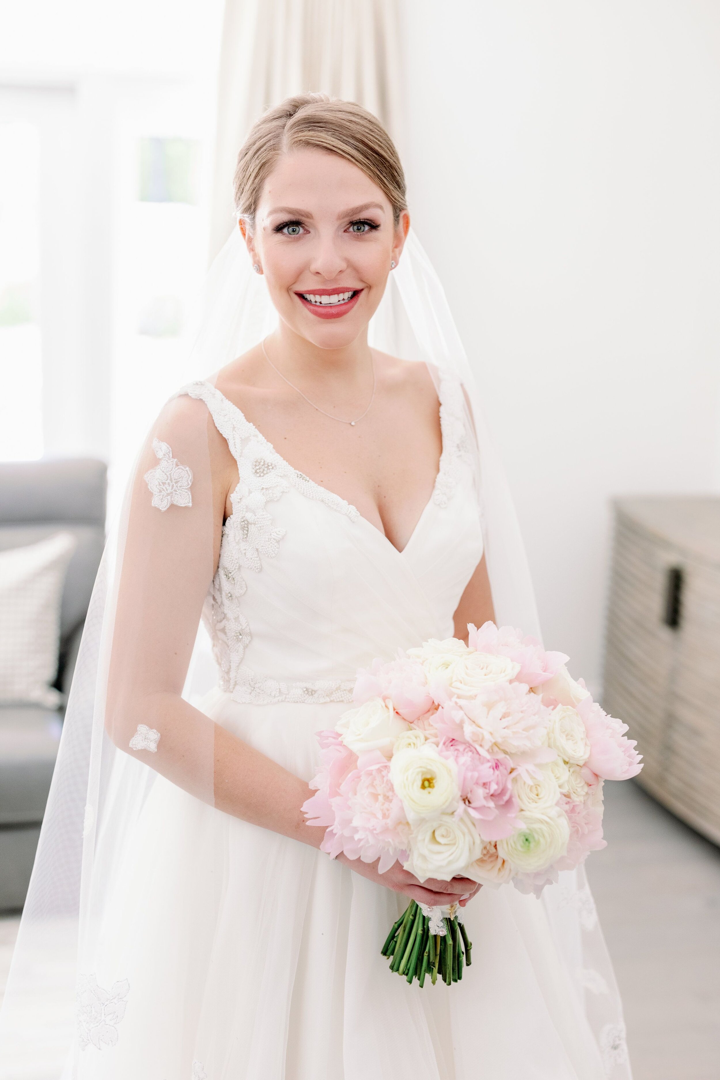 Bride in Wedding Dress Holding White and Blush Bouquet.jpeg