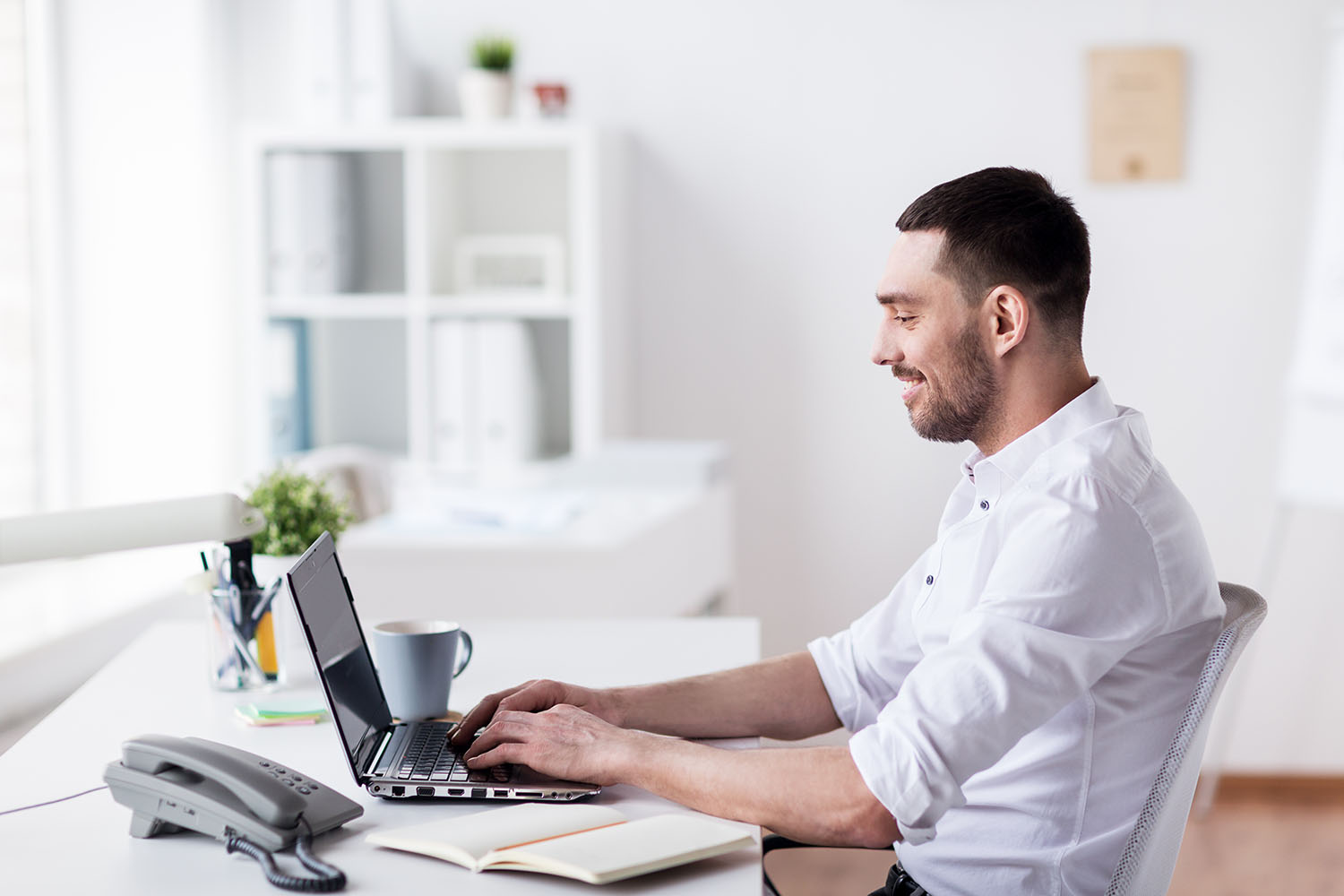 photodune-20196384-happy-businessman-with-laptop-at-office-xxl.jpg